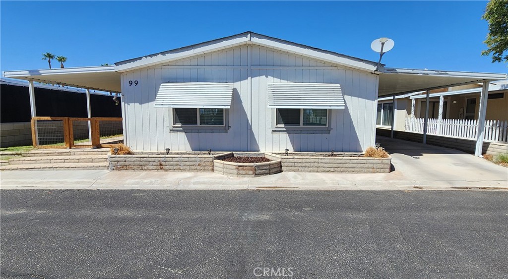 Welcome to the Mesa Bluffs Village, an established manufactured home community. The park is peacefully nestled above the beautiful Blythe valley and is only a stone’s throw away from the local municipal golf course, Palo Verde College, and the Colorado River. This charming home features 3 bedrooms, 2 bathrooms, and 1,344 square feet of living space. It also comes equipped with a large open living room, kitchen with breakfast bar, separate dining room, and indoor laundry room. Appliances include refrigerator, gas range, dishwasher, washer and dryer. In 2022, there were many noteworthy upgrades, including all plumbing, HVAC system, evaporative cooler, water heater, carpet and laminate flooring, and two bedroom windows. And it’s one of the few units in the park with a yard. You won’t find a nicer home at this price point; this is affordable living at its very best!! Come see it before it’s gone!