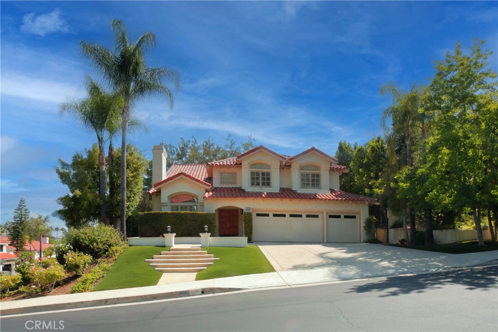 Nestled in the desirable guard-gated Calabasas Hills, this J.M. Peters 4-bedroom, 3.5-bath home offers 3,174 square feet of living space on a 9,557 square foot lot. It features high ceilings, vinyl plank flooring, and fresh paint. A downstairs bedroom with a full bath adds convenience, while the upstairs includes the primary suite and two additional bedrooms. The primary suite boasts a balcony overlooking the lush backyard, an en-suite bath with a soaking tub, dual sinks, and a spacious walk-in closet. A separate laundry room adds extra practicality. The peaceful backyard offers a private jacuzzi for relaxation and a patio perfect for outdoor dining or morning coffee. The attached 3-car garage provides direct access and plenty of storage. Community perks include two pools with spas, playgrounds, and a park. The home is within walking distance of Bay Laurel Elementary in the sought-after Las Virgenes school district and is close to the Commons, Old Town Calabasas, the Saturday Farmer's Market, the Calabasas Tennis and Swim Center, and just a short drive to the Malibu coast.