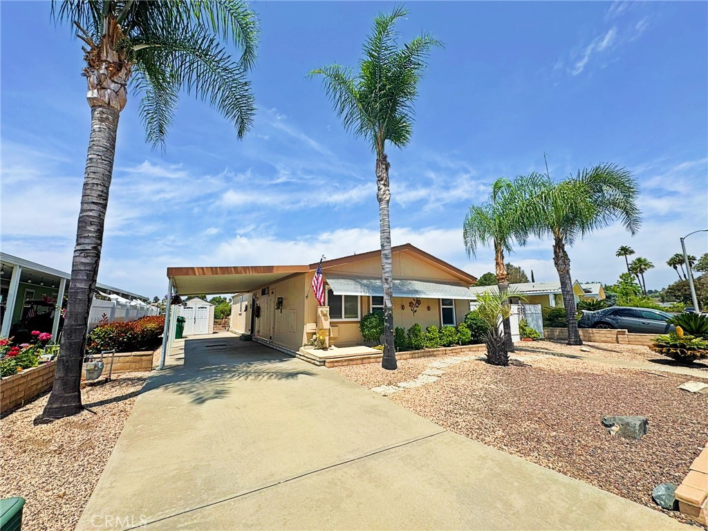 Welcome home to your view single story, serene and tranquil living home in the 55+ neighborhood of Warm Spring Knolls. Located on the view side of the development sits an upgraded home with everything you could ask for including wood-like luxury vinyl flooring, enhanced baseboards, two-tone interior paint with crown molding. The entire home has recessed ceilings, giving it an open and airy feel. The open Kitchen boasts real wood cabinetry with faux granite Formica countertops and ALL stainless steel appliances. The open kitchen overlooks the family room and dining area, which also overlooks through your dual panes vinyl windows to the open Canyon views. All luxury vinyl dual paned windows also have highly desired wood shades or custom privacy cellular shades. This is a wonderful floor plan with separate laundry area with tons of built-in storage and cabinetry. The full size guest bathroom sits across the secondary bedroom, also with raised ceilings for a very open feel. Second bedroom has a ceiling fan for those warm nights as well as a mirrored wardrobe closet. Master bedroom sits at the end of the hallway with mirrored wardrobe closets and direct access to your master bathroom. This bathroom has it all with extra storage cabinetry, a custom step-in bath, dual vanity sinks, as well as a full-sized shower. As you walk out your front door, you also have a full covered patio with enclosed vinyl fencing surrounding your home. This area is fabulous for outdoor entertaining, and has lots of shade! In the rear of the backyard you will find an apple tree and walkway of pavers that lead to another full covered patio with views of the serene canyon! This backyard has lots of paved outdoor shaded entertainment areas! On the other side of the home is your extra long covered driveway and carport with plenty of room for extra cars. The exterior of this home is extremely charming in the sense that it has very low maintenance, but also has the warmth of beautiful palm trees, fruit tree and shrubs. This home has been a beautifully maintained over the years and is ready for its next owner!