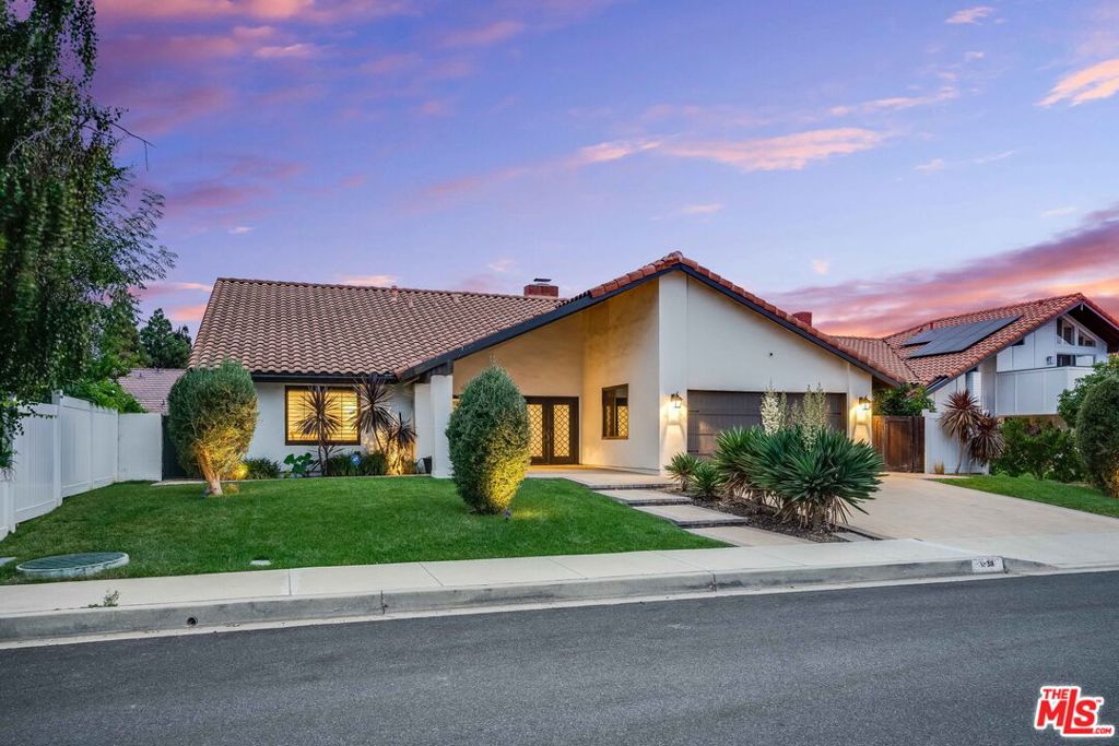 Welcome home! This move-in ready, single-story Mediterranean retreat is located on a quiet cul-de-sac in the charming community of Westlake Hills.Step through the decorative iron double doors into a home designed for both elegant entertaining and comfortable living. You'll find gorgeous wide-plank European Oak flooring and impressive soaring, beamed ceilings. The open-concept floor plan features a formal living room as well as a more casual family room that flows into the impressive chef's kitchen.The kitchen is a true highlight, featuring a massive island topped with a luxurious, leather-finished quartz countertop, and a full suite of premium Jenn-Air appliances, including a gas range, column refrigerator and freezer, separate two-drawer refrigerator/freezer, and a dual-temperature wine refrigerator.The private primary suite offers a spacious bathroom, complete with a dual-head shower and a separate walk-in closet. Two additional generous bedrooms share a full bathroom, and the fourth bedroom has been converted into a welcoming office space.Enjoy seamless indoor-outdoor living with beautiful accordion glass doors that fully open to the gorgeous landscaped yard. The backyard is a private oasis with a bistro-lit, pergola-covered patio, a built-in barbecue area, and a gas fire pit. On the side of the property, you'll also find mature avocado and orange trees.The attached, oversized 2-car garage features the ability to charge 2 electric vehicles, and the home has been pre-wired for solar panel installation.This home is just steps away from Westlake Hills Elementary and offers easy access to the community's endless walking paths and parks.