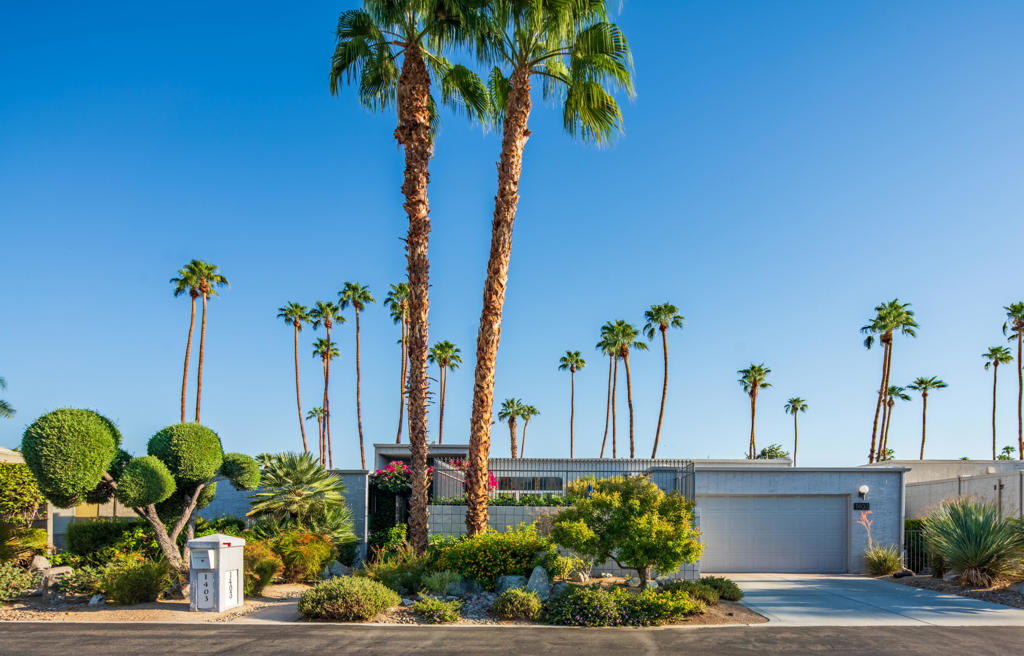 Welcome to 1403 Tamarisk West Street, a mid-century modern residence by the legendary architect S. Charles Lee, whose iconic Hollywood theaters helped define California's architectural legacy. This 2-bedroom, 2-bath home offers 2,376 square feet of light-filled living space, thoughtfully updated to preserve its original character while incorporating modern comforts.From the moment you step through the bold entry door, you're greeted by high ceilings, expansive glass walls, custom motorized shades and panoramic views of lush landscaping and the sparkling community pool. The Great Room features multiple sitting areas, a double-sided slate fireplace, built-in bookcases and a wet bar. The seamless indoor-outdoor flow is ideal for entertaining.The updated kitchen features sleek cabinetry, granite countertops, a glass tile backsplash, and newer stainless-steel appliances. A small private paver patio with a built-in BBQ completes the separate dinette area. Both oversized bedroom suites offer updated bathrooms with spa inspired walk-in showers and walk-in closets. The primary suite bathroom also has a free-standing soaking tub.Energy-efficient upgrades include leased solar panels, two HVAC systems, recessed LED lighting and a tankless water heater. The home sits on a 4,792 sq ft lot with a private front courtyard with southern mountain views. The backyard includes a covered patio complete with ceiling fans and a beautiful view of the community pool and surrounding lush landscaping.Located in the prestigious Tamarisk West community with direct access to Tamarisk Country Club, this home is minutes from the Agua Caliente Casino, The River, El Paseo, Sunnyland's, and the Palm Springs International Airport. Whether you're seeking a seasonal retreat or a full-time residence this home delivers sophistication and serenity with a convenient location.