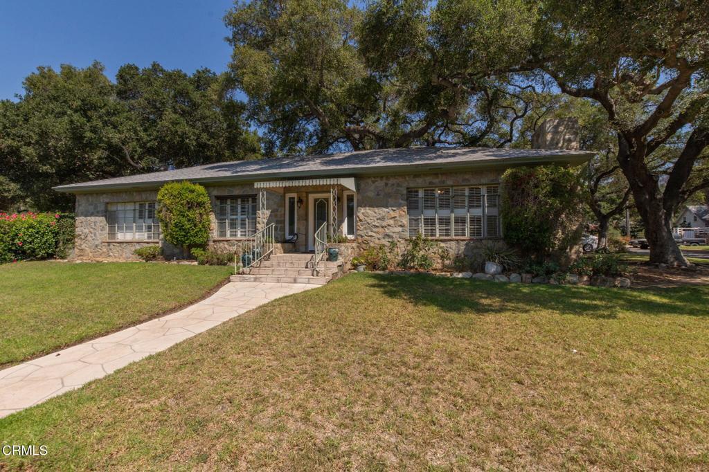 This charming 1947 single-story home presents a timeless appeal with its distinctive rock exterior. Positioned on a corner lot and shaded by a picturesque canopy of mature oak trees, the residence presents a classic post-war era aesthetic.Stepping inside the 1647 sq ft interior, you'll discover a floor plan that includes three bedrooms, two bathrooms, and a separate formal dining room, offering spaces that are both comfortable and functional. It has the prettiest front door in the neighborhood.The living area features a warm and inviting fireplace, a signature detail of homes built during this period.The enclosed carport, a practical feature, provides a secure space for vehicles, and hints at a design approach that valued functionality and practicality.While the home retains its original character and some vintage charm, it is ready for some updating and restyling to bring it into the 21st century while still honoring its historical roots.This presents a fantastic opportunity to blend classic elements with modern amenities and create a unique and personalized living space.