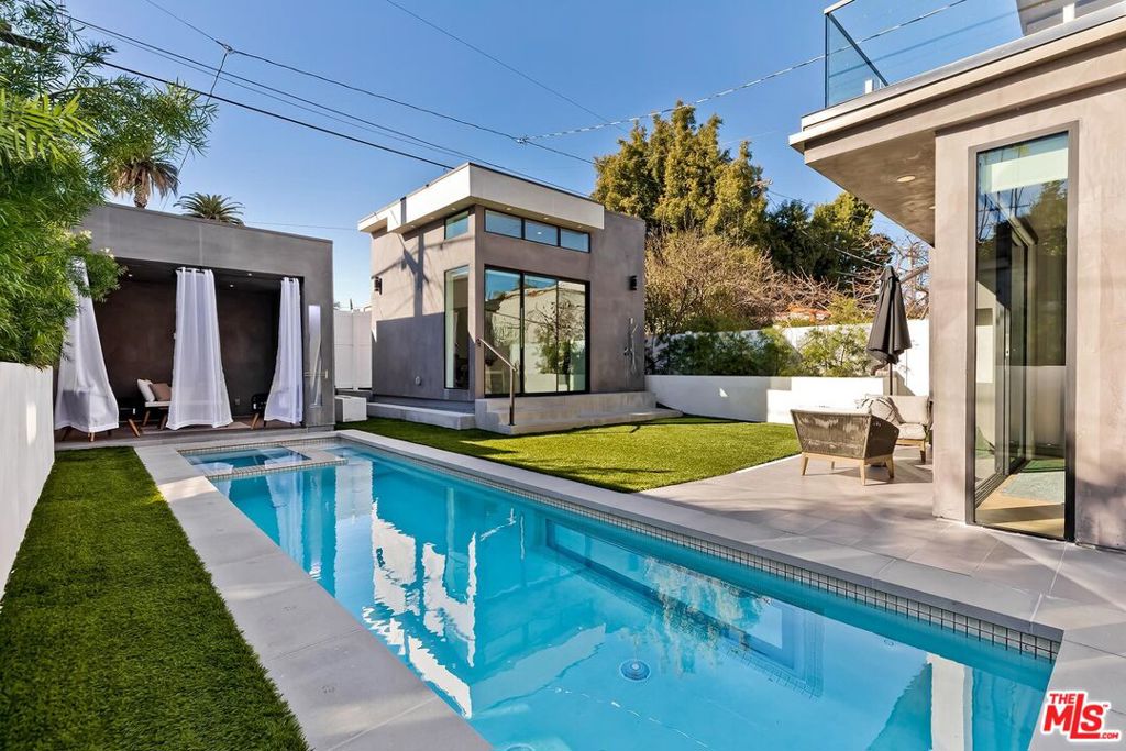 Exquisite brand new built 2022 modern villa with 3-levels of extraordinary living & entertaining areas in desirable Beverly Hills adjacent(1st home from Beverly Hills). A fully equipped home with 3 levels of living areas, separate guest house, cabana, fire pit, pool & spa tub, 2 car garage, elevator... Formal entry way to all entertaining areas with family room w/ fireplace, dining area, wine cellar and gourmet kitchen with an oversized center island all with direct access to the entertainers' backyard. The first floor also features a two car garage and guest's powder room. Sliding doors takes you to the private entertainers' backyard w/sparkling pool & spa, cabana, massive fire pit and lounging areas with shower. Outdoor area also features contemporary guest house with high ceilings, central air, little kitchenette and bathroom. Luxury living continues upstairs with an additional family room, 3 bedroom suites including a pristine master suite with fireplace, sliding glass doors- leading out to a private balcony overlooking the backyard, walk-in closet, and a spa-like bath with large steam shower, soaking tub, dual sinks and vanity area. Underground level offers big ballroom, wet bar, temperature-controlled wine cellar, patio and incredible large underwater window view of the pool. In addition, this level has a bedroom suite with full bathroom, gym and a den/office/maid room with full bathroom. Top notch amenities include security cameras, smart home system, surround sound, elevator, pool, spa, guest house, laundry room, central vacuum, 2 car garage and more. Lower level (basement) 1443 sqft * First floor 1023 sqft * Second floor 1195 sqft * Recreation room (guest house) 200 sqft * Cabana 144 sqft * Garage 346 sqft.