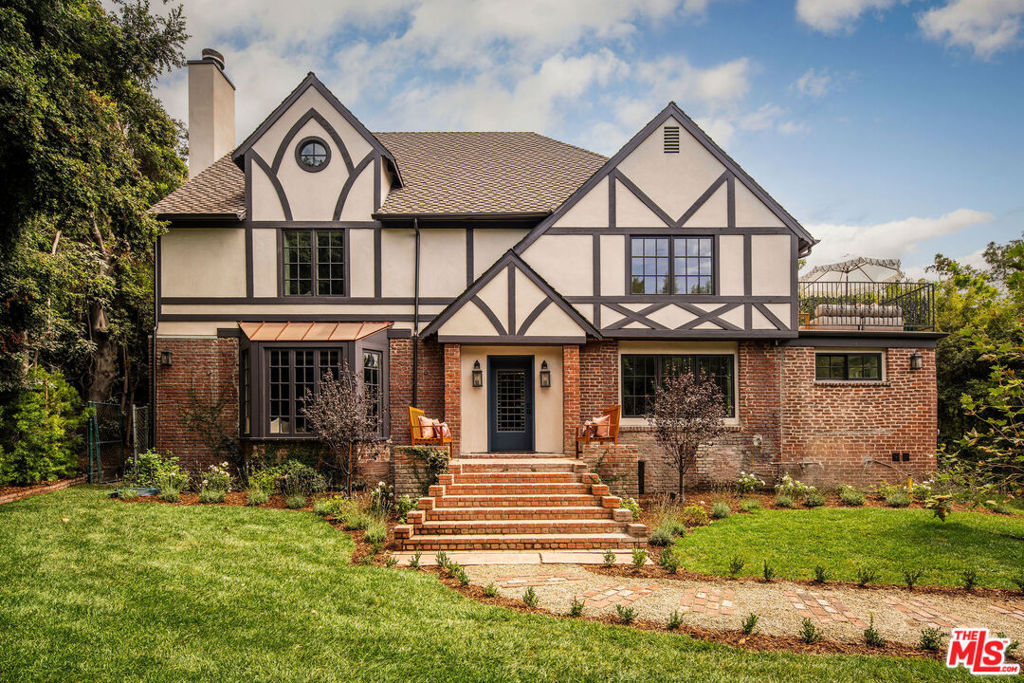 Welcome to an exquisite blend of historic charm and modern luxury at 2246 North Edgemont Street in Los Feliz. A refined 1921 Tudor masterpiece, reimagined by the esteemed Maple Design LA x AV Studio, this home offers a captivating blend of elegance and functionality. Encompassing 3,875 square feet, the residence features 5 bedrooms, 6 bathrooms plus so much more. Each space is meticulously crafted to honor the home's original character while introducing sophisticated updates. Upon entry, you're welcomed by a grand foyer with soaring ceilings, leading to an expansive living room adorned with an original bay window and a cozy fireplace. The adjoining den and formal dining room provide additional areas for relaxation and gatherings. The gourmet kitchen is a chef's paradise, highlighted by a large custom marble top island and a butlers pantry, ideal for culinary creations. The layout includes a full guest suite on the main level, ensuring privacy and comfort for visitors. Upstairs, discover four generously sized bedrooms, including a grand primary suite with a luxurious soaking tub and a private balcony offering stunning views of the serene pool area. Each additional bedroom is spacious and thoughtfully designed, featuring vintage glass windows, private balconies, and pool views. The laundry room has been meticulously tailored to meet the household's needs. Custom tile work, elegant sconces, and bespoke lighting fixtures grace each room, enhancing the timeless ambiance. Outside, the home captivates with a sparkling pool, complemented by a jacuzzi, waterfall, pool shower, barbecue area and an outdoor bathroom. Nestled on a generous 11,686 square foot lot, this outdoor oasis provides ample space for a variety of activities and leisure pursuits, inviting you to savor the best of both relaxation and recreation. This historic gem, situated in the coveted neighborhood of Los Feliz, embodies a perfect blend of timeless elegance, exclusive privacy and modern sophistication.
