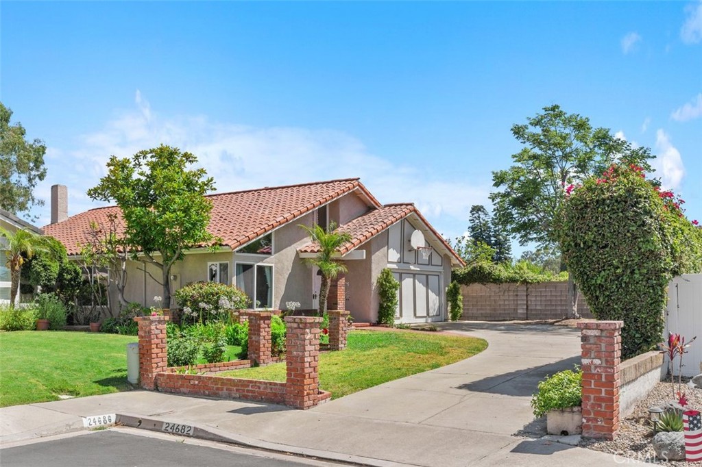Welcome to 24682 Via Tequila, a rare single-level opportunity in the heart of Lake Forest. This 4-bedroom, 2-bathroom home offers over 1,800 square feet of living space on a large lot with inviting curb appeal, highlighted by a red tile roof, brick accents, and a welcoming double-door entry. Step into a bright and spacious floor plan with vaulted ceilings in the formal living and dining areas, enhanced by large windows, recessed lighting, and a blend of travertine tile and carpet throughout. The family room features a cozy gas and wood-burning fireplace and opens to the upgraded kitchen, which includes rich cherry cabinetry, granite countertops, a farm-style sink, double ovens, and stainless-steel appliances—ideal for entertaining or everyday living.
The primary bedroom is generously sized with direct access to the backyard, while the ensuite bathroom and the additional full bath are mostly original, providing a great opportunity for custom updates. Three additional bedrooms offer flexibility for guests, family, or a home office. The oversized backyard offers both privacy and potential, with mature landscaping and a flourishing lemon tree—ready for your personal touch.
Additional features include an oversized driveway, central A/C, and low HOA dues. Located in the highly regarded Saddleback Valley Unified School District, this home also offers convenient access to freeways, toll roads, shopping, and dining. As part of the master-planned Sun & Sail Club community, residents enjoy resort-style amenities including three pools plus a children’s wading pool, tennis and pickleball courts, a full-size basketball court, two sand volleyball courts, a large children’s playground, a fitness center, and a beautiful clubhouse overlooking the lake with year-round community events.
With just a few finishing touches, this home is ready to shine. Don’t miss the chance to make it your own in one of Lake Forest’s most sought-after neighborhoods.