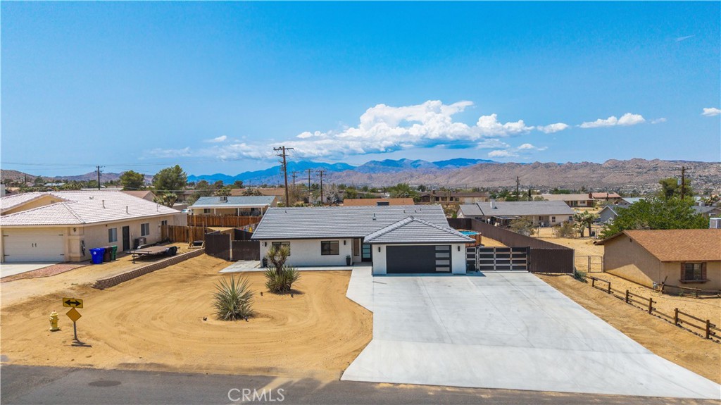 Discover the perfect blend of custom design, modern efficiency, and desert tranquility in this thoughtfully built 2021 Yucca Valley home. From the moment you step inside, you’ll notice the tall ceilings and open-concept layout, creating a bright and spacious atmosphere that’s perfect for both relaxing and entertaining. The kitchen features hand-designed custom cabinetry and quartz countertops, offering both style and functionality for everyday living.
The garage is a true standout, fully insulated and climate-controlled with its own 2-ton mini split system, extensive cabinet storage, and a kitchenette setup with sink and fridge hookups. It’s ideal for car enthusiasts, creatives, or anyone who wants a flexible workspace or hobby area with all the comforts of home.
Outside, the property is designed for easy outdoor living. Enjoy a large shaded patio with wraparound concrete, perfect for BBQs, gatherings, or quiet evenings under the stars. There’s also dedicated RV parking with electrical and septic hookups, along with custom fencing and gates for added privacy and convenience.
Enjoy the benefits of owned solar and a fully insulated interior for low energy bills, making the home efficient and cost-effective year-round.
This is a rare opportunity to own a home that combines modern upgrades, thoughtful design, and flexible spaces, whether you’re looking for a full-time residence, a weekend retreat, or a home base for all your desert adventures.
