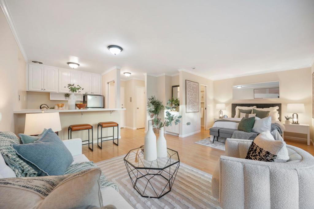 Welcome to Unit 210 at 928 Peninsula Avenue, a stylish studio, 1-bath condo in San Mateo's resort-style Woodlake community. This updated unit features serene courtyard views, laminate flooring, flush ceilings, and a quartz kitchen with glass cooktop. Ideal for first-time buyers or investors seeking low-maintenance living with high convenience. Woodlake offers 26 acres of lush grounds and premium amenities: six pools, four tennis courts, a gym, spa, sauna, putting green, and playground. The secure building includes intercom access and coin-op laundry. Pet-friendly with HOA rules. Enjoy walkable access to Safeway, Starbucks, CVS, and Woodlake Shopping Center. Minutes from downtown San Mateo, Burlingame, Central Park, Coyote Point, and the Bay Trail. Commuter-friendly location near Hwy 101, Caltrain, and SFO. HOA covers water, garbage, insurance, and common area maintenance. A turnkey Peninsula gem!