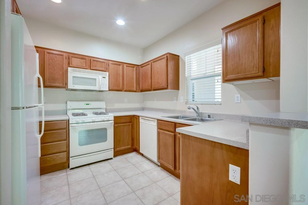 Welcome to this beautifully maintained second-story condo in the gated and highly desirable Verona community — ideally situated just steps from the pool, spa, and gym. Light, bright, and move-in ready, this home offers a fresh neutral palette, large windows, recessed lighting, and remote-controlled ceiling fans throughout. The well-equipped kitchen features matching white appliances, a gas cooktop, built-in microwave, and plenty of cabinet space. Enjoy durable hard flooring in the main living areas and plush carpeting in the bedrooms for added comfort. Stay cozy year-round with central A/C, a gas fireplace, and your own private patio perfect for morning relaxation or evening company. Added convenience includes in-unit laundry and a detached one-car garage. Located on the border of Temecula and Murrieta, you’ll love being just minutes from shopping, dining, and recreation — all in a vibrant, welcoming neighborhood.