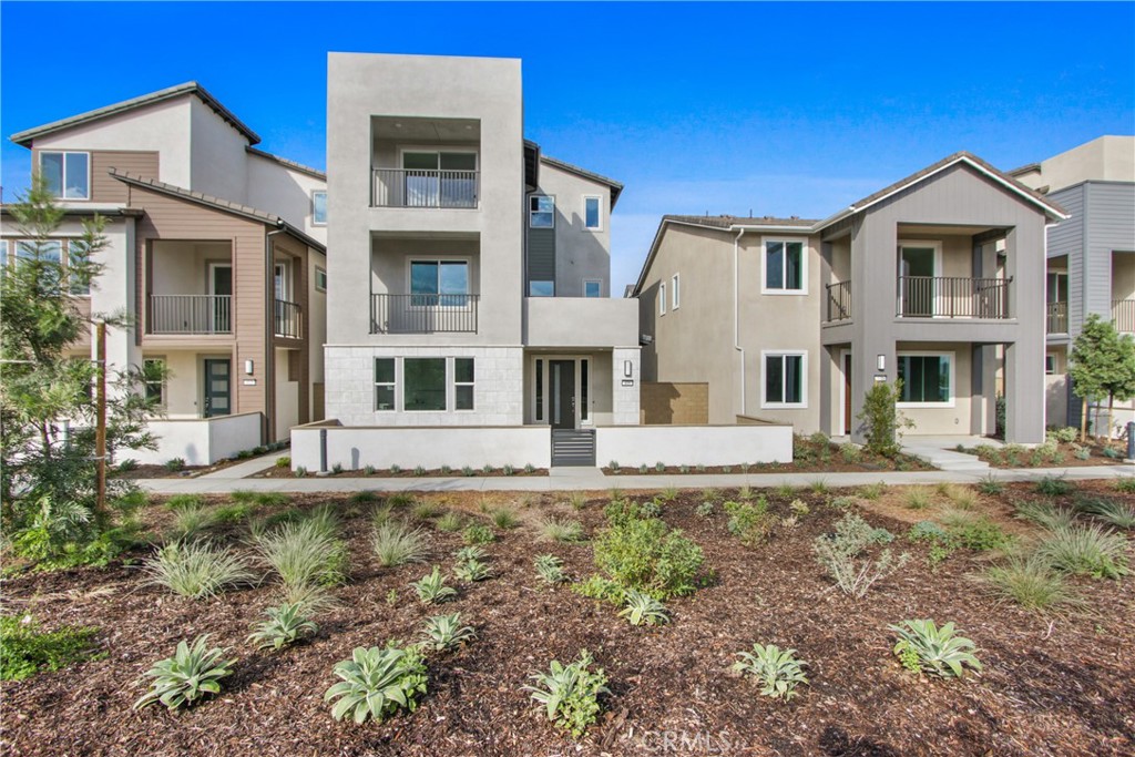 Be the very first to live in this stunning, brand-new Lennar Estela Plan 3 "Contemporary C" model home, perfectly situated in the desirable Luna Park at the Great Park Neighborhoods in Irvine. This exceptional 3-story residence offers 2,888 sq ft of modern living space, featuring 4 bedrooms and 4 bathrooms. The heart of the home is on the second floor, boasting a bright and airy open-concept layout where the gourmet kitchen, equipped with new GE appliances, flows seamlessly into the dining and living areas. This level also includes a full bedroom, bathroom, and a covered deck perfect for enjoying the Southern California weather. The third floor is a private retreat, featuring a luxurious owner's suite with a large walk-in closet, an elegant en-suite bathroom, and access to a second covered deck. An additional bedroom, a versatile loft space, and a full laundry room complete this level. Throughout the home, you'll appreciate the extensive flooring upgrade, which includes a sophisticated mix of engineered wood, plush carpeting, and elegant tile. This property's standout feature is the revolutionary first-floor Next Gen® suite, which functions as a "Home Within a Home®". With its own separate, private entrance, this space is perfect for in-laws, a home office, or a private guest retreat. The suite is thoughtfully designed with a spacious living area, a modern kitchenette, a private bedroom, a full bathroom, and its own laundry closet with a brand new Maytag stacked washer and dryer. Live efficiently and enjoy significant energy savings with a powerful 4.92 kW solar system paired with a Tesla Powerwall for energy storage and backup. The attached 2-bay garage is also equipped with a Tesla EV charger, making this home as forward-thinking as it is beautiful.