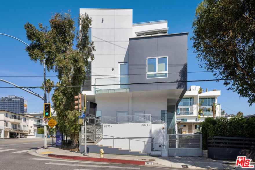 Striking Architectural Modern Townhome - Ideally located in the most desirable area of West Hollywood. The residence features open concept living areas with essential outdoor flow and creative spaces that allow for a flexible use for an owner to customize their living experience with convertible bedrooms to offices, media rooms, etc. The direct-entry first level features; kitchen with custom cabinets, stainless appliances, quartz countertops and travertine tile flooring. An entry, living room and dining area are light filled with a retractable wall of glass that opens to an alfresco dining patio. A powder room and dark hardwood flooring throughout. The second level consists of two guest rooms, two baths, laundry closet, and a small balcony. The primary bedroom suite occupies the entire upper level with incredible spa-style open-concept bath with dual vanity, glass shower, soaking tub, and dual closets. A spacious private rooftop deck offers amazing 360 degree views encompassing vistas from downtown LA to the westside, landmarks and the Hollywood hills. A built-in barbecue kitchen area, and lounge areas are perfect for entertaining or simply relaxing in the sunshine. Central air and heat, secure access, 2-car gated parking garage with storage. Ideally located between the famous Sunset and Santa Monica boulevards, steps to the Sunset Strip; luxe shopping, cafes, grocery, nightlife, top restaurants. Zoned for the prestigious West Hollywood Elementary. Only two-units are in the building making this a rare opportunity with low HOA dues.