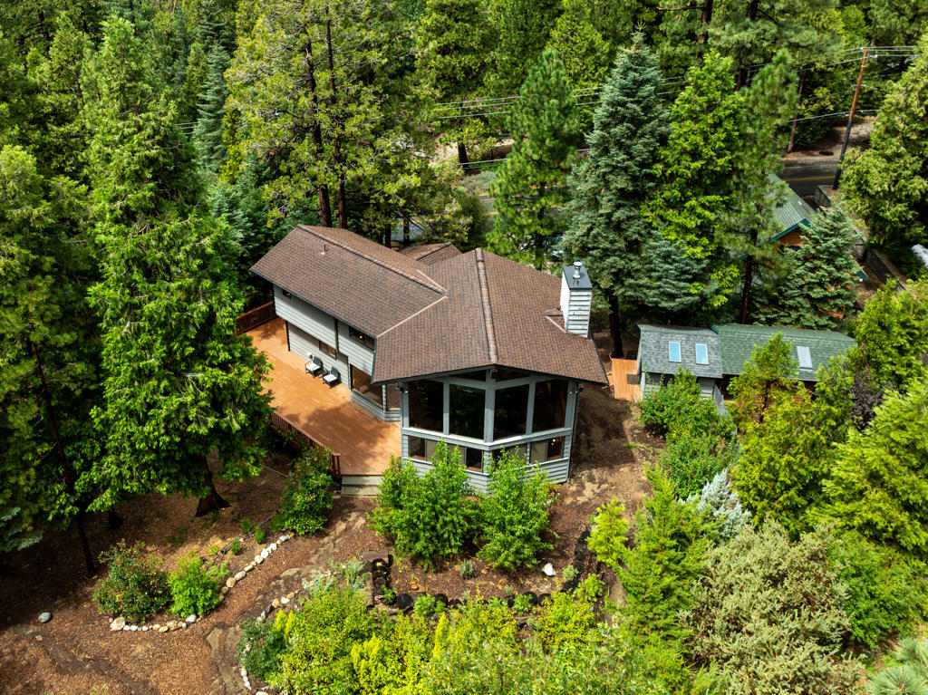 Mountain modern meets early contemporary design in a desirable upper Fern Valley location. This impressive home features an open floor plan with soaring vaulted ceilings, huge windows that let in tons of natural light, views of the South Ridge and Lily Rock so close you'll feel you can reach out and touch. Amazing views continue outside from the beautiful mountain garden on a gently sloping .56 acre lot with a mini orchard. Upstairs the master bedroom overlooks the living area and has an en suite with a Japanese style tub and picture window. Downstairs is another spacious bedroom with bathroom next door. The layout of the home is very functional. The basement level is accessed from the main floor of the house and includes a large utility room with an entrance to the garage and would make a great art studio or office space. A large deck provides great space for outdoor entertaining. Additional amenities include a sauna, outdoor shower and a small finished out building for storage or extra guests. Overall this property is a wonderful example of a mountain living, ready to inspire its next owner.