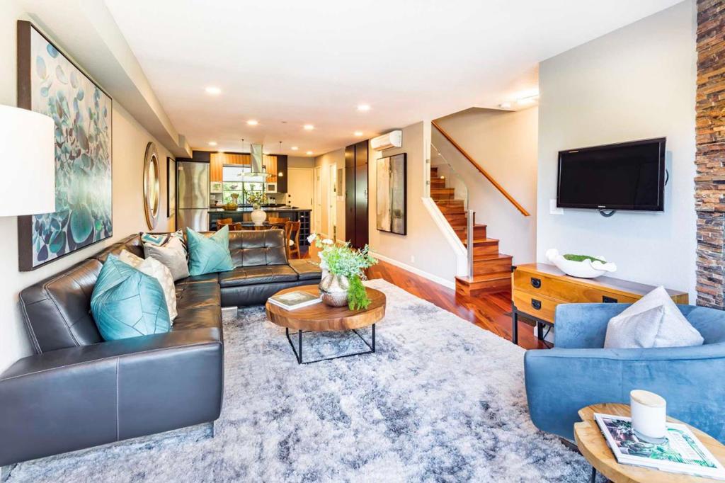 A modern downtown lifestyle awaits in this stylish 2-bedroom, 2.5-bathroom condo just 2 blocks away from University Avenue. Gorgeous hardwood floors extend through almost 1,100 sf of dynamic living space beginning in the light-filled living room with a fireplace. From there, the dining area flows into the remodeled kitchen with Caesarstone counters & appliances from Wolf, Bosch, Fisher-Paykel, and Liebherr. Two bedroom suites include one with a private entrance from inside the complex, and the master suite with a spectacular spa-like bathroom. Both bathrooms incl. Porcelanosa tile. This home also offers a sun-soaked front balcony and private backyard patio, while an in-unit laundry closet as well as carport parking provide added convenience. Just moments to the incredible boutiques and eateries of downtown Palo Alto, this home is also just around the corner from beautiful Heritage Park, and it is convenient to Stanford University, the Stanford Shopping Center, and Caltrain.