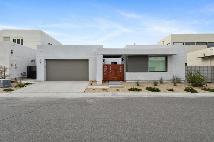 Located in the gated community of Miralon in Palm Springs, this modern home offers resort-style living with a spacious open-concept design, tile floors throughout, and expansive mountain views. The primary suite includes an en-suite bathroom with a walk-in shower and dual vanities.The kitchen is equipped with high-end appliances, a large pantry, and an oversized island, opening to the great room with a sliding glass wall for seamless indoor-outdoor living. Each bedroom provides direct access to the yard, creating a strong connection between indoor and outdoor spaces.The backyard is designed for relaxation and entertaining, featuring a covered patio, pool, and spa.Residents of Miralon enjoy a variety of amenities, including heated pools, a spa, fitness center with Peloton bikes, yoga studio, bocce courts, U-pick gardens, dog parks, a community chef's kitchen, and an on-site cafe and bar. Conveniently located near downtown Palm Springs and major highways, this home combines comfort, luxury, and accessibility.