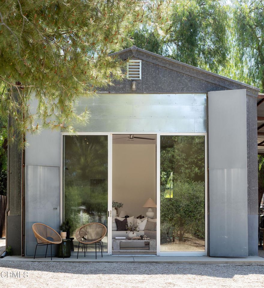 A One-of-a-Kind Artistic Sanctuary! Nestled within lush, thoughtfully landscaped grounds, you'll find a recently remodeled and irresistibly charming 2-bedroom cottage that feels lifted from the pages of Architectural Digest. The home blends simple elegance with modern comfort, featuring Italian porcelain tile flooring, a sleek, updated bathroom, and a stylish kitchen equipped with premium Fisher & Paykel appliances. Upgrades extend behind the scenes as well, with a newer HVAC system and a tankless water heater. Outside, a shaded, fenced yard and a covered patio provide peaceful retreats, while a scenic stroll through your very own olive grove leads to the showstopper: a converted metal barn with soaring 13-foot ceilings--now a light-filled, inspiring studio space perfect for artistic pursuits. There's room to expand within the 1/2 acre compound with plenty of space for gardens, a future pool, and ample off-street parking--including covered RV storage. The sellers have already started the ADU plans for you. Whether you're seeking solitude, inspiration, or simply a truly unique property, this home delivers. Come experience the magic for yourself--this is more than a home - it's a creative retreat waiting to welcome you.