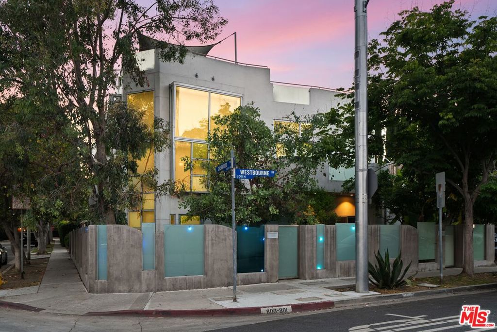 Iconic Architectural Duplex | Expansive Rooftop Terrace: 801-803 Westbourne Drive presents a rare opportunity to own a custom-built trophy property in the heart of West Hollywood's coveted Tri-West neighborhood. Built in 2007, this stunning showpiece features two impressive units and a newly redone, one-of-a-kind rooftop terrace with sweeping 360-degree city views - The Ultimate Entertainers Retreat. Both units offer secure direct-entry parking, a private courtyard, in-unit laundry, and secure gated access. The property comprises 2,601 SF, and is perfectly situated on a 3,628 SF prime corner lot just steps from Santa Monica Boulevard and a short walk to Melrose Avenue. Top Unit (#801): Features 3 bedrooms, 2 bathrooms, and approximately 1,500 SF of living space, highlighted by a dramatic 30-foot vaulted entry with large metal-framed windows, pecan hardwood floors, and an open layout filled with natural light. The living room includes a gas fireplace, while the kitchen is equipped with stainless steel appliances and a pass-through window to the living area. The unit also offers a private balcony and direct rooftop deck access via two private staircases. Bottom Unit (#803): Offers 2 bedrooms and 2 bathrooms across approximately 1,100 SF with a spacious open floor plan, contemporary finishes, and a private outdoor patio. Travertine floors extend through the main areas, and the kitchen features sleek cabinetry, quartz countertops, and stainless steel appliances. Bathrooms include walk-in rain showers and an oversized soaking tub. The unit also includes a wraparound yard. With a WalkScore of 88, the property enjoys direct access to some of the best dining, shopping, and entertainment in the city. Just minutes from Soho House, Urth Caff, Sweat Yoga, the Pacific Design Center, Cedars-Sinai, and more. Do not disturb tenants.