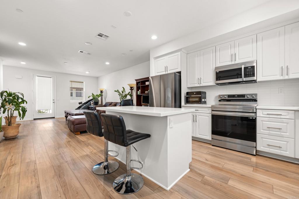 2024-Built Modern Tri-Level Townhome! Soaring 9-ft ceilings, abundant light & owned solar with no Mello Roos. Open-concept main level with spacious living area & sleek kitchen featuring stainless appliances, large island & great storage. Dual primary suites upstairs, plus versatile 1st-floor bedroom/office. Private balcony with park-like views, 2-car garage & laundry room. Community BBQs, garden, tot lot. Prime La Mesa/Lemon Grove border—minutes to shops, dining & downtown SD. Move-in ready!