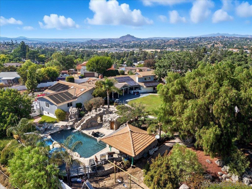 Just what you've been waiting for! Very private ranch-style home in cul-de-sac atop highly desirable Granite Hills. Surrounded by peaceful landscape & mountain & twinkling city lights views, this fully fenced 5 bed/4 bath has wood flooring & natural stone throughout, 2 fireplaces & a very open floor-plan. Entertainers dream includes pool w/ slide & waterfall, jacuzzi, spa, sauna, outdoor shower & palapa w/ seating bar, sink & mini-fridge. Gorgeous brand new outdoor kitchen & BBQ area right off main living room under huge covered patio. Mature orchard & garden area, small putting green, tons of parking & storage including RV parking w/ hook-ups. Spacious out-building could easily be converted to ADU. Lots of options for multi-generational living. Most bedrooms have en-suite bathrooms. Leased solar with low payment is huge money saver!