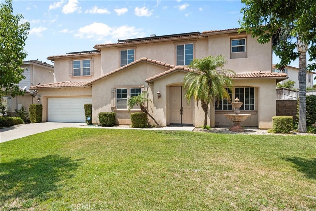 Spacious Home in a Sought-After Community.
Welcome to Rancho Vista North, a private gated community where comfort and convenience come together. This beautiful 4,130 sq. ft. home sits on a generous 10,913 sq. ft. lot and was designed with easy living in mind. Inside, you’ll find 4 large bedrooms (including a main-floor en-suite for guests or multigenerational living), 4 full bathrooms plus a convenient half bath downstairs. The open-concept kitchen is perfect for dining and entertaining, featuring stainless steel appliances, double oven, granite counters and granite island, cherry wood cabinets, a butler’s pantry, and plenty of space to gather. The kitchen flows into the oversized family room, complete with a cozy fireplace—an inviting spot for evening movie nights. Upstairs, the primary suite is a true retreat with two walk-in closets, a spacious sitting area, and a luxurious bathroom with soaking tub, glass-enclosed shower, dual sinks, and vanity. A second oversized bedroom with its own en-suite bath offers extra flexibility, while the upstairs loft/landing area makes a perfect homework station or tech center. Additional bedrooms and a Jack-and-Jill bathroom provide room for everyone. Step outside to the covered patio, ideal for year-round barbecues and gatherings. A 3-car tandem garage offers ample storage and direct access to the laundry room and powder bath. The home also comes with an assumable (or payoff option) solar lease to help with energy efficiency. You are in the top-rated Etiwanda School District, with Etiwanda High School just a short walk away. Shopping, dining, and entertainment at Victoria Gardens are only minutes away, plus easy access to the 15 and 210 freeways makes commuting simple. This is more than a house—it’s the place where you can create lasting memories.