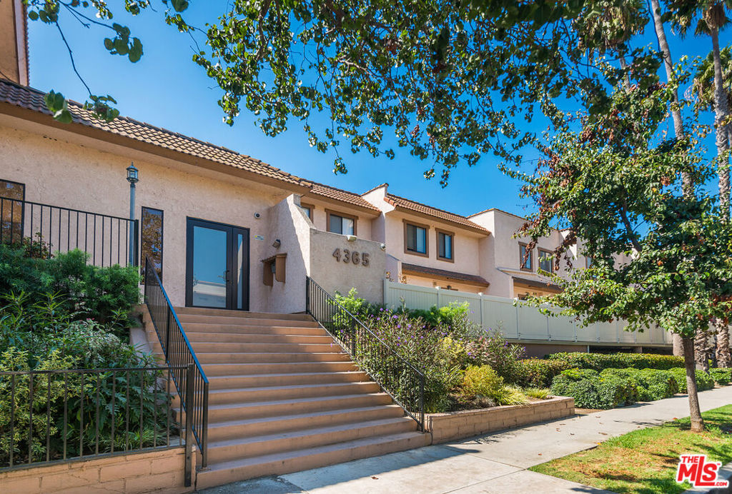 This spacious two-bedroom townhome in Mar Vista offers the scale and comfort of a single-family home with the ease of condominium living. An open-concept layout welcomes you inside where natural light pours through large sliding doors, creating a bright and uplifting atmosphere throughout the main living spaces. The living room and dining area are centered around a fireplace and open onto a private patio, perfect for indoor-outdoor enjoyment. The kitchen has been refreshed with crisp white counters, stainless steel appliances, and bold blue cabinetry, adding a touch of character. Upstairs, two generously sized bedrooms provide comfort and privacy, including a primary suite with ample closet space and a beautifully updated bathroom. Wide-plank flooring throughout enhances the modern feel. The community is well cared for, featuring a pool and a private park ideal for both children and pets. Additional benefits include earthquake insurance, side-by-side parking, and extra storage in the garage. The building has planned updates that will add to the property's appeal. Tucked away on a quiet cul-de-sac, the home enjoys close proximity to the Ballona Creek bike path, Mar Vista's beloved farmers market, and an array of excellent local restaurants offering a lifestyle of comfort, convenience, and connection.