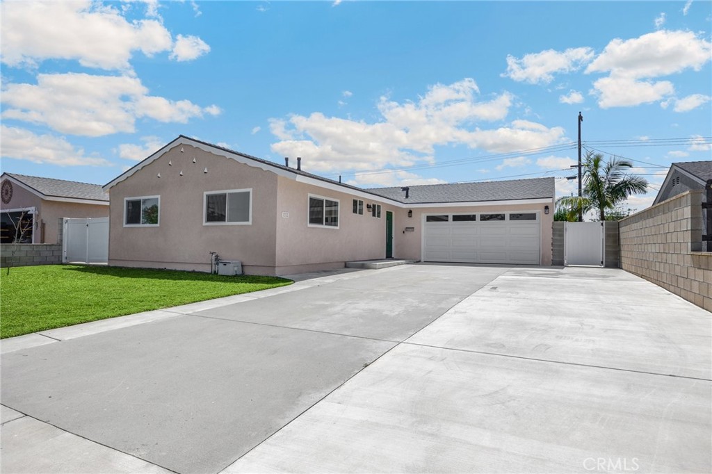 Fall In Love with this absolute stunner, Beautifully Upgraded Single Story Ranch Style Home with 3 Bedrooms, 2 Bathrooms, and Open Floor Plan. This Turnkey Beauty is Located in a Wonderful Neighborhood on a Quiet, Interior, Tree-Lined Street. with Gorgeous Curb Appeal that Includes a Lush Manicured Landscaping, Newer (about 50 Foot Long and about 23 Foot wide) Driveway that Can accommodate an RV or Boat parking. The generous side yard provides many options for expansion or outdoor entertaining. Newer Garage Door equipped with myQ LiftMaster Garage Door Opener that works in tandem with its App via WiFi. The home has been updated. The Kitchen Remodel is a Chef’s Dream Featuring Granite Countertops, Abundant Custom Shaker Soft-Closing Cabinetry, Double Sinks, New Garbage Disposal, and Stainless Appliances, Including Gas Range, Microwave, and Dishwasher. The home also comes with Scraped Ceiling and New Recessed Lights, New bathroom fans. All windows have been updated to Dual Paned Windows, New Sliding Door, New Luxurious Life Proof Vinyl Flooring throughout the house, Central A/C, Over 5 Inch High Baseboards, New Raised Panel Interior Doors, and New Remote Controlled Ceiling Fans in all 3 Bedrooms, and Living Room. New Exterior Lights, Newer Stucco. The Sliding Door Opens to a Huge Backyard that Exudes Tranquility with a mature Orange and Lemon trees. The Backyard has complete Privacy with Block Wall Fencing. It is perfect for Entertaining family and friends or adding an ADU. Both Bathrooms have been Beautifully Updated. The Primary En-Suite Bathroom has a Walk-In Shower and a New White Vanity with Quartz Countertop, Tile Flooring, Huge Shampoo Niche, Large size Tiled Walls, New water-saving Toilet, New Custom Shower Door, and All New Fixtures. The Full Bathroom Features a Tub/Shower Combo with Floor-to-Ceiling Large Tiled Walls and Huge Shampoo Niche, New White Vanity with Quartz Countertop, New water saving Toilet and all New fixtures. Both Bathrooms have updated plumbing. There is Direct Access to the 2-Car Garage where the Washer and Dryer Hookup is located. The Garage Has Built-In Storage Cabinets and a Workbench. This Home is Located in the Anaheim Union High School District which includes The High-Ranking Oxford Academy. The home is minutes from Cypress College, also Close to Shopping Centers, Restaurants, Local and Theme Parks such as Disneyland and Knott’s Berry Farm, as well as Easy Freeway Access. This Home is a "MUST-SEE!"