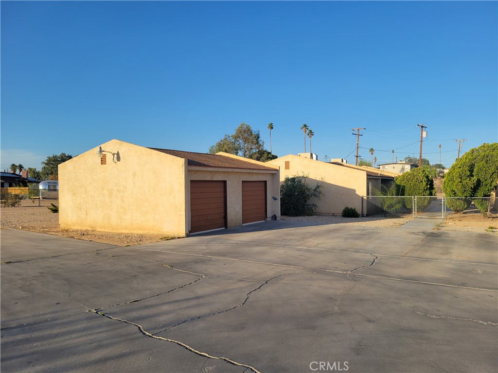 Excellent investment opportunity in the growing Four Corners area of 29 Palms! This well-maintained 4-plex residential income property features four identical 2 bedroom, 1 bath units, each designed for comfortable living and strong rental appeal. Each unit offers a spacious living room with durable tile flooring throughout, creating a clean and low-maintenance interior. The kitchens and living areas are open and functional, while the bedrooms are generously sized with ample closet space and plenty of natural light. Bathrooms in all units feature a convenient tub/shower combo. Tenants will appreciate the added convenience of individual garages, located in a detached garage structure on site—providing covered parking or additional storage for each unit. Situated near local amenities, schools, and just minutes from the Marine base and Joshua Tree National Park, this property is ideally located for both long-term and short-term tenants. With strong rental potential and a practical layout, this 4-plex is a solid addition to any investor’s portfolio.