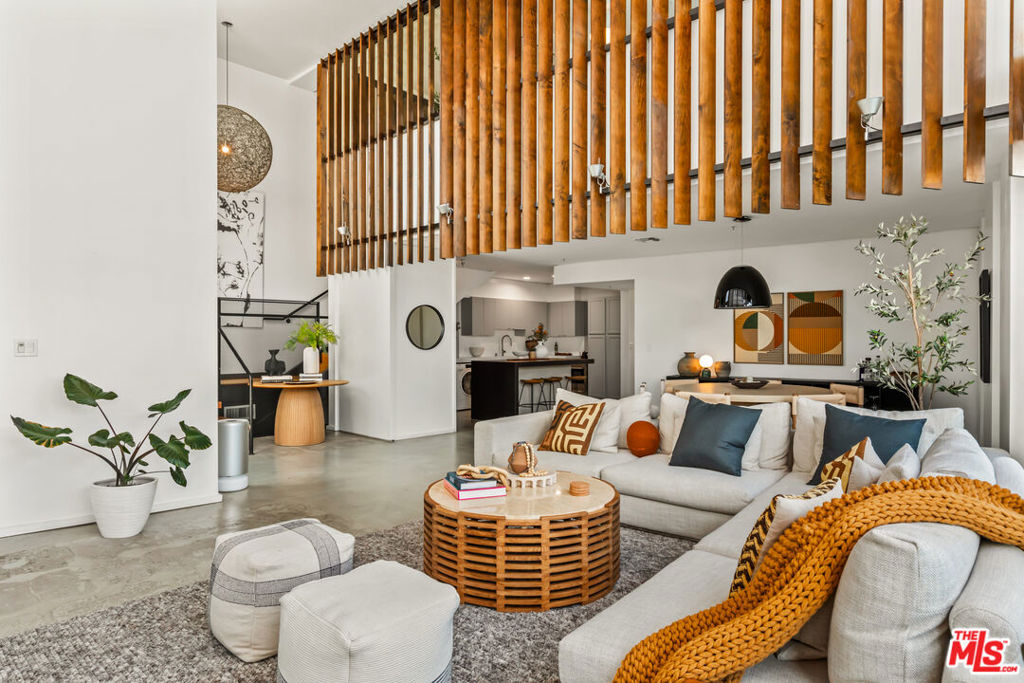 Just moments from the sand and tucked just off Abbot Kinney and Rose, this impeccably designed architectural live/work residence captures the essence of beach living while offering remarkable flexibility. With soaring 18-foot ceilings and walls of glass, the interiors are bathed in natural light, creating an inspiring canvas for how you live, work, and play. The open floor plan flows effortlessly, featuring 4 bedrooms, 2 baths, and multiple bonus spaces that invite endless possibilities. Imagine hosting gatherings in the expansive living room, creating in a sunlit studio, working from home in your dream office, or carving out a serene yoga or meditation retreat. The versatility here is unmatched. Indoor and outdoor living merge seamlessly with a spacious private patio extending from the main living area. Whether it's morning coffee in the sunshine, al fresco dinner parties, or a quiet evening under the stars, the space adapts to every mood and moment. Upstairs, a flexible loft adds even more dimension, equally suited for guest quarters, a second workspace, or a lounge to unwind and recharge. Privately set as a back-corner unit with its own private entrance, this residence balances sophistication with comfort. Practical luxuries include gated 2-car side-by-side parking, guest parking within the building. And when you're ready to step out, Venice Beach, Abbot Kinney's boutiques, and Rose Avenue's vibrant dining are all within easy reach. More than a home, this is a lifestyle; modern, soulful, and endlessly adaptable.