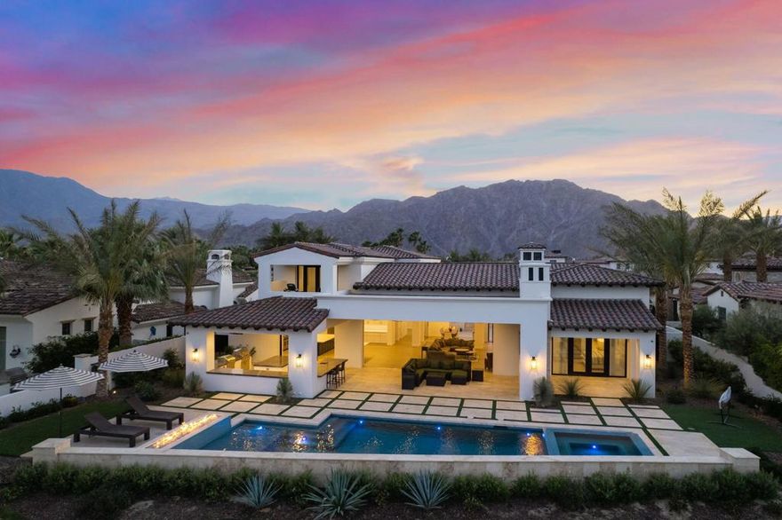 Exquisite newly constructed home, with double fairways views across the 13th and 14th holes of the Pete Dye golf course. This stunning home features 5 bedrooms, 5.5 bathrooms, plus a versatile bonus room that could be used as a home gym, theatre, or 6th bedroom, for a total of 5,713 sqft. Step through the gates into the courtyard with tranquil water feature then into the great room with floor to ceiling glass doors that pocket away for seamless indoor/outdoor enjoyment. This gorgeous custom home has an expansive open concept layout for the ultimate in entertaining. The chef's kitchen features a large center island and glass pocket doors to the incredible outdoor kitchen and bar. The formal dining room has glass corner pocket doors that open to the courtyard plus a beautiful glass wine wall to showcase your finest vintages. The primary bedroom has soaring ceilings with clerestory windows and glass french doors to a private patio with two-sided fireplace. The primary en-suite offers a separate soaking tub, large shower, dual vanities and dual walk-in closets. The private casita located on the courtyard with outdoor fireplace also has a separate living room. The second floor offers three spacious en-suite guest rooms. The largest of the guest rooms has a covered balcony with views of the golf course, lake and chocolate mountains. The roomy outdoor living area features a large covered patio with TV's beside the shimmering pool, raised spa and fire feature.