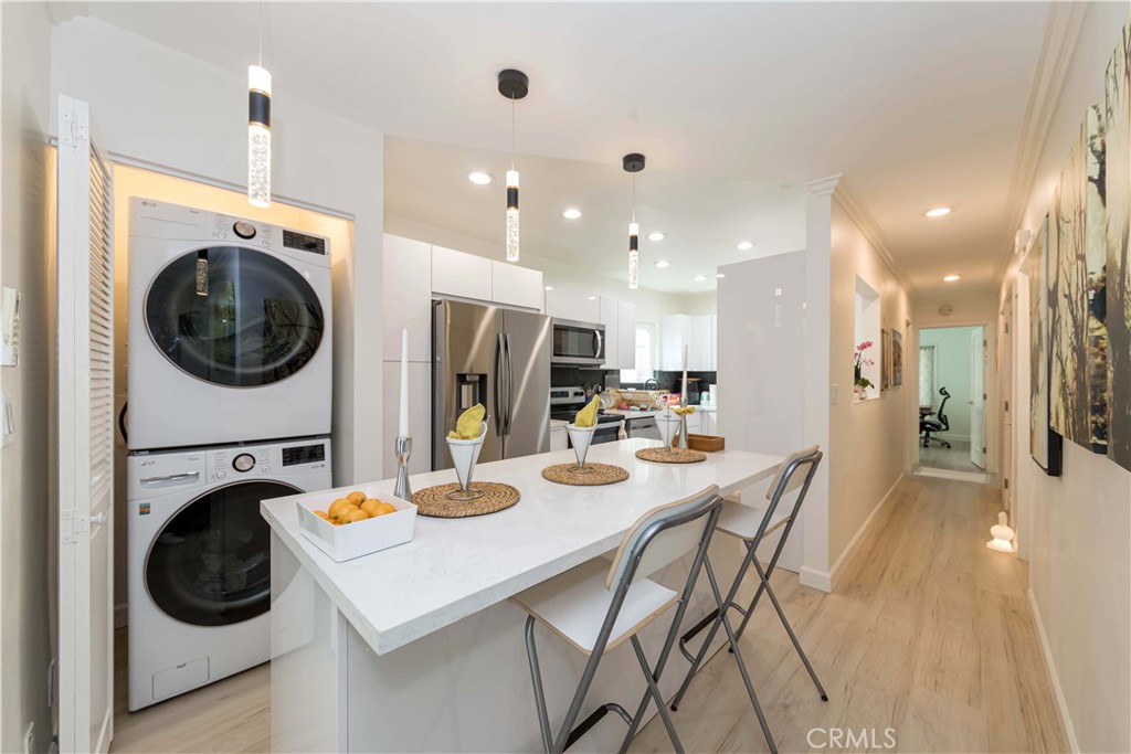 WELCOME TO 645 N GRAMERCY PLACE, A RARE GEM IN THE HEART OF THE HANCOCK PARK NEIGHBORHOOD, HOLLYWOOD AND MID-WILSHIRE, WHERE MODERN UPGRADES MEET TIMELESS CHARM AND FUTURE POSSIBILITIES. THIS FULLY REMODELED DUPLEX SITS ON R3-ZONED LAND, OFFERING BOTH IMMEDIATE COMFORT AND POTENTIAL. BOTH UNITS ARE OCCUPIED AND ONE DOWNSTAIRS UNIT WILL BE DELIVERED VACANT. GREAT OPPORTUNITY FOR AN OWNER LIVING OR GOOD FOR THE RENTAL INCOME INVESTMENT! EACH SPACIOUS UNIT FEATURES 3 BEDROOMS PLUS A BONUS DEN OR OFFICE, AND 2 BEAUTIFULLY UPGRADED BATHROOMS WITH MODERN BIDETS, DESIGNER TILE, AND SLEEK FIXTURES. THE OPEN-CONCEPT LIVING SPACES ARE FILLED WITH NATURAL LIGHT, ENHANCED BY TRIPLE-PANE WINDOWS, NEWER KITCHENS WITH STAINLESS STEEL APPLIANCES, COLOR-CHANGEABLE LED RECESSED LIGHTING, AND WARM HARDWOOD FLOORS THROUGHOUT. BOTH UNITS ARE EQUIPPED WITH IN-UNIT LAUNDRY, AND EACH DETAIL HAS BEEN THOUGHTFULLY CHOSEN FOR BOTH FUNCTION AND STYLE. BEHIND THE SECURE WROUGHT IRON GATE, THE PROPERTY OFFERS 8+ GATED PARKING SPACES, INCLUDING A 2-CAR GARAGE, A PRIVATE DRIVEWAY, AND EVEN AN EV CHARGING STATION. A SURROUND SECURITY SYSTEM OFFERS PEACE OF MIND, WHILE THE UNBEATABLE LOCATION, MINUTES TO LARCHMONT VILLAGE, PARAMOUNT STUDIOS, KOREATOWN, AND DTLA MAKES THIS HOME AS CONVENIENT AS IT IS CHARMING. WHETHER YOU'RE AN OWNER-USER LOOKING FOR SPACE AND INCOME, OR AN INVESTOR EXPLORING THE FUTURE BENEFITS OF R3 ZONING, THIS DUPLEX OFFERS THE PERFECT BALANCE OF COMFORT, POTENTIAL, AND LOCATION.