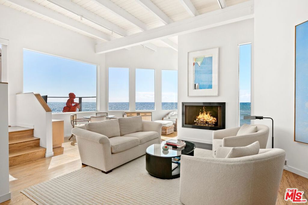 Providing spectacular sunsets over the Pacific Ocean and with endless views from Catalina to Channel Islands, this home has one of the widest beachfrontages on Malibu Road at over 83 feet - resort-style living at its finest. The open floor plan provides ocean views that extend from the kitchen, dining area, sitting area and step down living room. Vaulted ceilings and a fireplace add to the ambiance of the living area. The main floor opens to an expansive beach front deck featuring a built-in spa and incredible sea life sightings of seals, dolphins and seasonal whales. There is also a large patio in the front that provides an intimate sitting area for relaxing, barbecuing, and dining as well as a private staircase for easy beach-access. The ocean front primary suite on the main floor offers a beautiful sleeping environment with a fireplace, sitting area and an ensuite bathroom that includes privacy smart glass that goes from translucent to opaque with a flip of a switch. Upstairs provides two additional bedrooms and 2 additional baths. With a private two-car direct access garage and easy parking for 5 additional cars, the proximity of this home is just down the street from the high-end and family-friendly restaurants and retail shopping such as Ollo, Bui Sushi, Lucky's, Cross Creek Malibu Country Mart and Nobu, which all makes this Malibu Road home California living at its best!