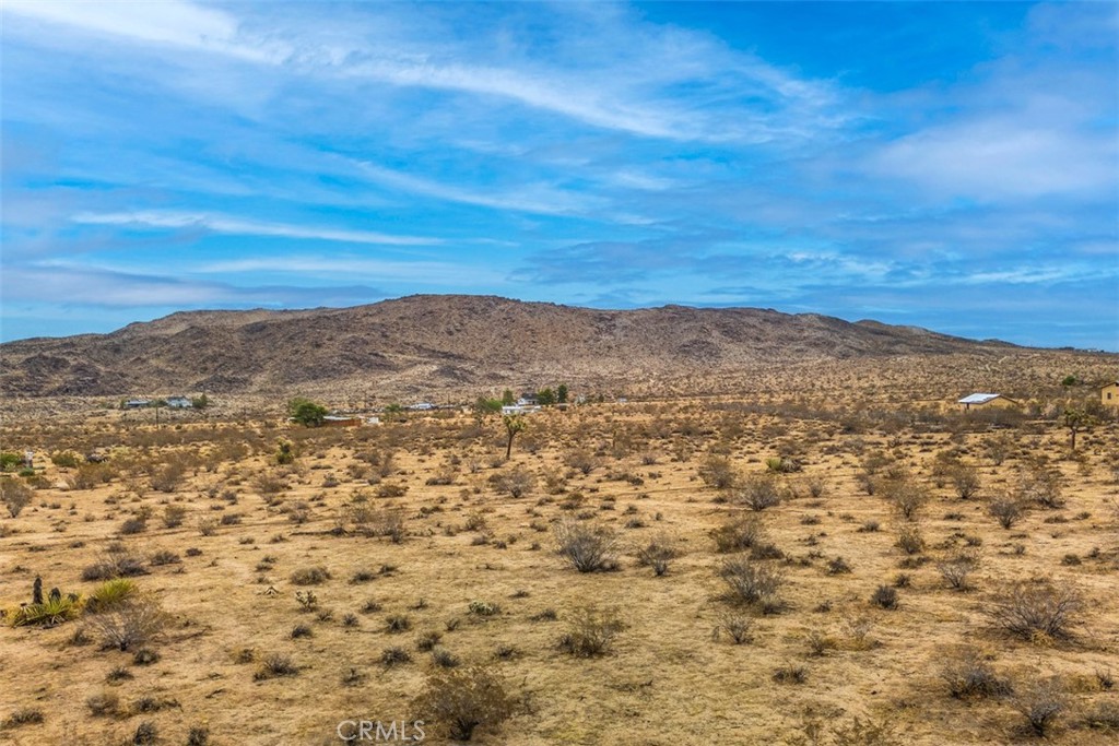 Discover the perfect blend of space, privacy, and convenience with this 5-acre parcel in Landers, CA, offering endless possibilities for your desert lifestyle. Located just 20 minutes from Yucca Valley shopping and dining, this property provides a peaceful retreat while keeping you close to town amenities. The lot already comes with valuable improvements, including a paid-off water meter, a solid concrete slab, and a fenced yard, giving you a head start on development. Access is simple and convenient, with the property located just off paved Linn Road. Whether you’re planning a custom desert home, a manufactured residence, a horse property, or a private high-desert getaway, this parcel is a true blank canvas. Enjoy wide-open views of the surrounding mountains, iconic desert landscapes, and star-filled skies. The location also places you close to unique Landers attractions, including Integratron, Giant Rock, Gubler Orchids, Sound Bath experiences, and the Morongo Basin Historical Museum, while still being a short drive to Joshua Tree National Park. This is your chance to own a piece of the high desert with tremendous potential—perfect for full-time living, a vacation retreat, or a smart investment in the growing Landers area. Don’t wait—schedule a viewing today and start envisioning your desert dream.