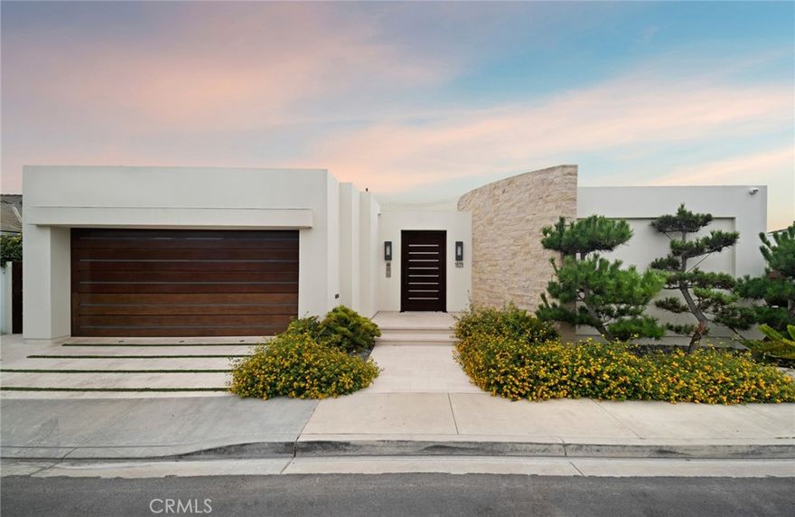 Located in one of the most coveted bluff-front locations in all of Newport Beach, this single-level contemporary estate captures unobstructed vistas stretching from the harbor entrance and Balboa Peninsula beaches to Catalina Island, Palos Verdes, and beyond. Expansive ocean horizons, vibrant sunsets, and sparkling city lights provide a captivating backdrop for everyday living. Thoughtfully designed with architectural precision, the residence showcases soaring ceilings, open living spaces, and the finest materials—cut limestone floors and walls, imported marbles, custom bronze doors and windows, and rich teak, walnut, and mahogany millwork throughout. The great room with its striking limestone fireplace and dining area opens seamlessly to the view terraces, covered alfresco lounge, lap pool, and spa, embodying effortless indoor-outdoor living. A gourmet kitchen is equipped with professional-grade appliances, marble countertops, a butler’s pantry, and walls of glass that draw the outdoors in. The private primary suite is a true retreat, appointed with curvilinear walnut-paneled walls, a spa-inspired marble bath, and a custom-fitted dressing room. Additional accommodations include a guest suite with ensuite bath, a den with bespoke built-ins, and a two-car garage. Set within the highly sought-after community of Irvine Terrace, this residence offers rare front-row living just moments from Newport Harbor, the Newport Beach Country Club, and world-class shopping, dining, and entertainment at Fashion Island.
