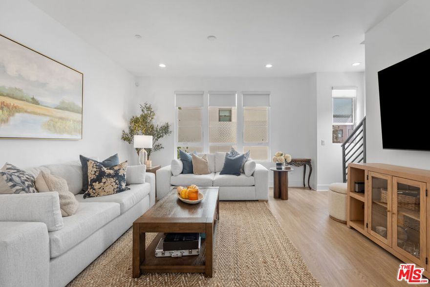 Bright Corner Unit in W. Toluca Lake!  Experience modern living at its finest in this stylish corner-unit single-family home located in the vibrant W Toluca Lake and close to the NOHO Arts district. This home offers an abundance of natural light through expansive windows and a thoughtfully designed open layout that blends comfort and sophistication.  The entry level offers a gated courtyard entrance to welcome your guests and direct access to a two-car garage, plus a spacious bedroom with an en suite bath, ideal for guests, a home office, or gym.  On the second floor, enjoy the airy open-concept living space that's perfect for entertaining. The modern kitchen includes a large quartz breakfast island, GE stainless steel appliances, and custom cabinetry. The kitchen opens into the dining area, and living room, all surrounded by windows that fill the home with sunlight from three sides of the home.  Upstairs, the third floor offers a secondary bedroom with en suite bath and a serene master bedroom with a spacious master bathroom, dual sinks, and a walk-in closet.  Ready to relax?  Head up to the rooftop deck to enjoy beautiful city views and a gas hookup for BBQs, perfect for relaxing or entertaining under the stars.  Situated just minutes from Valley Village, Burbank Airport, and Griffith Park, this bright and modern home combines effortless style with unbeatable convenience in one of the Valley's most sought-after neighborhoods.