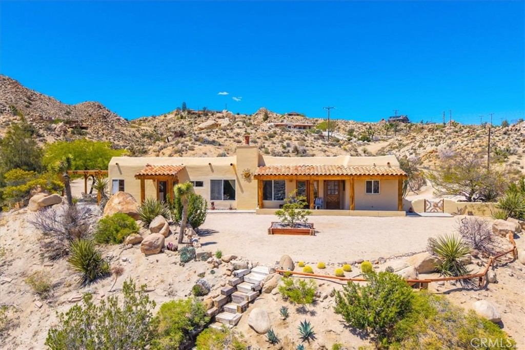 Discover a truly special property where breathtaking views and a prime location come together seamlessly. Nestled among majestic boulders to the north and dynamic vistas to the south and east, this home offers a sense of protection and inspiration at every turn.
This modern Spanish-style residence features 4 bedrooms and 2 baths, making it both practical and perfect for entertaining. Enjoy multiple covered patios that allow for seamless indoor/outdoor living, ideal for gatherings or quiet relaxation. Set on a spacious corner lot adorned with striking boulders and rock outcroppings, this hillside retreat provides an idyllic backdrop for nature lovers. There’s ample room to explore, hike, and even the potential to build your own ADU.
Step inside to admire the impressive details, including large natural log beams and Spanish tile flooring that exude charm and warmth. The abundance of double glass doors invites natural light, ensuring a picturesque view from every window. The kitchen is a chef's dream, featuring a Wolf stove surrounded by elegant granite countertops — you’ll be mesmerized by the stunning view from the sink window!
Conveniently located just off the pavement in the desirable Shatin Heights Community, you’ll benefit from a small annual fee that covers road maintenance, providing a sense of community without sacrificing privacy. This property is not just a home; it’s a sanctuary where stunning landscapes and contemporary living intersect.