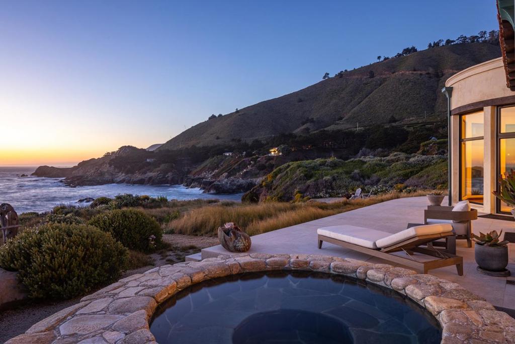 Located just a short distance from Carmel and Pebble Beach, Le Cap du Roc is a secluded haven offering sweeping oceanfront views and breathtaking vistas on its 2.8 acres in the prestigious gated Sea Meadow Community at Rocky Point. This 3,416 sqft home has been meticulously reimagined from the ground up by Holdren Lietzke with an effortless flow through the single-story layout, featuring floor-to-ceiling windows framing the stunning coastal scenes from almost every room in this 3 bed/3 bath residence. Past the spacious front driveway, you are welcomed into a sheltered courtyard with a gorgeously detailed outdoor fireplace and seating area, which is one of many outstanding spaces for indoor-outdoor gatherings and dinner parties. Other highlights include a hot tub and an expansive terrace with multiple seating areas, a gourmet kitchen opening into the living room and dining room with fireplace, luxurious spa-like suites, an office, and beautifully landscaped grounds with meandering pathways to explore, including a stone staircase with access to a rugged cove and the sea, where legend has it the notorious pirate LeRoc Corsaire hid his treasure in a secret cave in the 1700s. This is a rare opportunity for private oceanfront living just minutes from Carmel, Pebble Beach, and Big Sur.