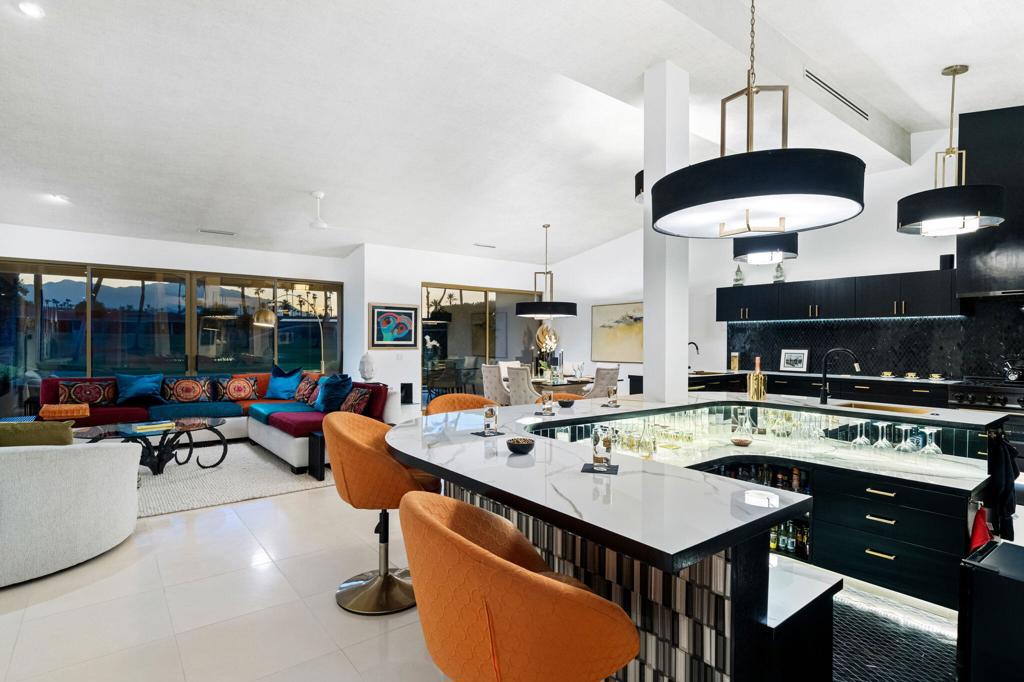 COUNTRY CLUB MODERN! This remodeled designer home is the essence of Desert sophistication in Private, Premier Desert Horizons Country Club. Sleek architectural lines & abundant natural light showcase the quality design of this 3 BD / 3.5 BA- 2,910 sf home that has been redesigned throughout! Fully furnished (art excluded). Enjoy seamless indoor-outdoor living with expansive windows framing the panoramic west mountain & golf course views. Enter through the private, enclosed courtyard to be greeted by a 12' art installation, ''The Aquarium,'' that showcases sparkling tropical glass fish in a light-filled atrium. This home is made for entertaining many and yet is perfect for two! Open-plan living area encompasses a sunken wet bar, living room w/fireplace, dining room & fabulous kitchen. Key features are: Owned Solar, imported stone finishes, new 2024 Lennox HVAC, cook's kitchen with Dacor refrigeration & 6-burner gas stove, Fleetwood sliding doors, power solar awnings & power solar shades, and more! See attached list detailing the extensive upgrades! Stunning street presence - Artificial turf, new lighting, custom gate & mature fruit trees. Located at the end of quiet cul-de-sac, with ideal proximity to community pool & dog walk areas. All homeowners are required to be Social Members (included in HOA fees). Desert Horizons CC has been renovated to include a gorgeous Clubhouse with bar & dining, state of the art fitness facility, green renovations on the Ted Robinson Sr designed course, new courts complex and more!