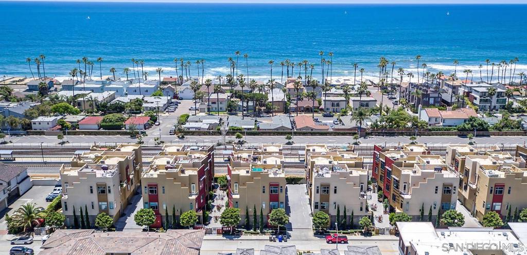 Huge Price Improvement! Panoramic ocean views and an incredible renovation. A rare opportunity! Introducing this newly renovated 2005 townhome with breathtaking panoramic ocean views and a private panoramic ocean view roof deck. This is one of only 7 townhomes in the community of 28 that has spectacular big blue ocean views from the kitchen and living room. Over $350,000 invested in this impeccable remodel, no detail was overlooked and this home shows like a modern chic beach home. This townhome has 3 bedrooms (one on the first floor), 3.5 baths, 2-car attached garage, over 2,040 sqft of living space and soaring ceilings on every floor. This townhome has so many high end features, including a dumbwaiter to the kitchen. With an HOA fee of just $500/month covering all exterior maintenance, you can enjoy minimal responsibilities and the freedom to lock up and go. This property offers unparalleled value that is hard to find in today's market. Just 2 blocks to the beach and located in the gated Coastal Townlofts, this exclusive community enjoys a prime location west of 101, offering not only panoramic ocean views but also 360 degree views with beach access. This community was custom built with a special variance, so this townhome has soaring ceilings that are 10-11ft on every level. Situated just a few blocks from the beach, the pier, and downtown, and a stone’s throw from the “quiet zone” Metro, this home provides unmatched convenience. This stunning front unit tri-level townhome offers a spacious and functional layout and an incredible location close to everything!