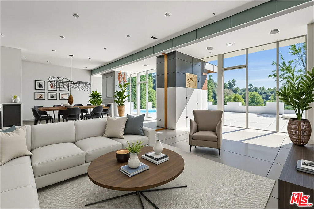 Mid-Century Modern with Boundless Potential. A Rare Opportunity for Visionaries and Investors Alike. For the first time in 36 years, this 1964 single-level corner-lot residence originally developed by Charles J. Provin and Hollywood Hills Development Corp. offers a rare opportunity to reimagine a timeless mid-century classic. In 1989, acclaimed architect Martin Roy Mervel, AIA (Studio D + R) updated the home with modernist sensibilities. Today, it awaits a visionary to restore or elevate its architectural character. Spanning 3,094 sq. ft., the home includes 4 bedrooms and 3 bathrooms, with the main living areas thoughtfully laid out on a single level. A short set of stairs leads to a separate fourth bedroom ideal as a guest suite, office, or creative studio. A showstopper living room of 830 sq. ft. features 11'4" ceilings, a dramatic fireplace, and an expansive wall of glass framing sweeping canyon and mountain views ideal for art collectors or those who love to entertain. Signature mid-century elements such as a central atrium, skylights, and clean architectural lines create a seamless indoor-outdoor flow and infuse the home with natural light. Outside, a newly renovated pool and spa with energy-efficient solar heating invite relaxed California living. Set on a generous 11,165 sq. ft. lot, the home offers total privacy, lush views, and potential for expansion. Additional features include a double garage, ample off-street parking, and an enviable location near a quiet cul-de-sac with sidewalks in Upper Laurel Canyon. Just moments from the exclusive Mulholland Tennis Club and within the top-rated Wonderland School District, this is an unparalleled opportunity to create your dream retreat in the Hollywood Hills. Furniture is virtually staged.