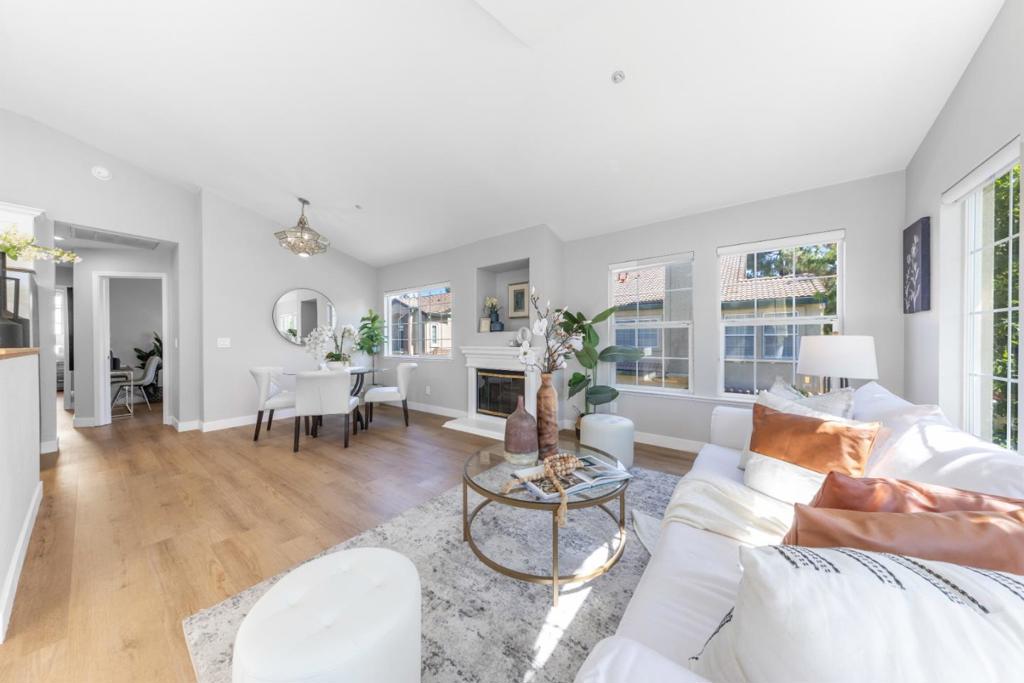 Tastefully renovated townhouse nestled in Siena Community, Pleasanton. Bright and airy living room with stunning grid-style windows exudes cozy atmosphere. Vaulted ceilings paired with elegant hardwood floors. The open-concept floor plan features kitchen, dining, living and a functional patio. The chef's kitchen is surrounded by wraparound island with white cabinets, Quartz counters, back splash, Stainless Steel appliances including gas range, dishwasher, refrigerator and high-end range hood. Enjoy outdoor living with a private Patio perfect for grilling. Spacious and comfortable master bedroom completed with mirrored closets and a private bath. Each bathroom is thoughtfully designed with exquisite tile floors, contemporary fixtures such as vanity, sink, faucet and elegant walk-in showers. An expanded closet in the hall offers stackable washer and dryer. Situated in the tranquil and pleasant community, within walking distance to Oracle & Kaiser, BART, Walmart & Wholefoods, city parks, theaters and a short drive to top-rated Pleasanton schools. Close to the intersection of Haicenda Dr and Owens Dr, with quick access to Highway 580/680.