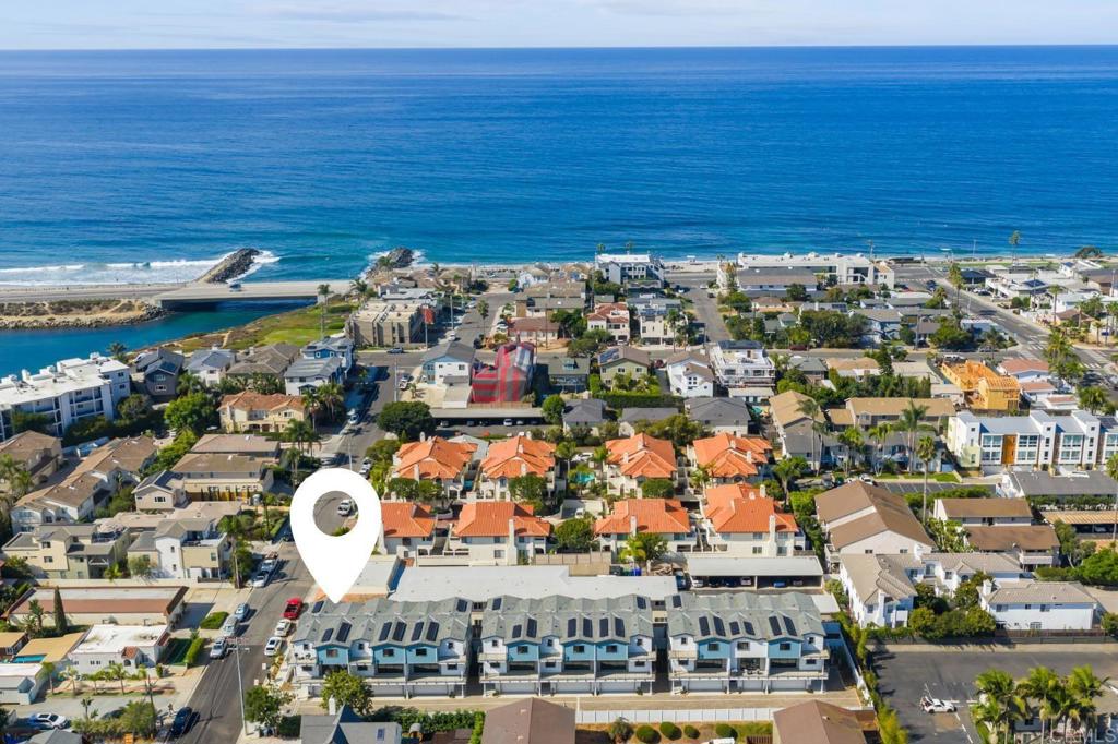 NEW construction, 2 blocks to Tamarack Beach! Experience coastal luxury at The Currents—a brand-new enclave of nine modern townhomes just steps from Carlsbad’s sunlit Tamarack Beach. *Builder is offering a generous rate buydown incentive. Special financing options available to qualified buyers.* Nestled on Chinquapin Avenue, this exclusive community seamlessly blends contemporary design with timeless seaside charm. 310 Chinquapin is a south-facing, end-unit residence offering 4 bedrooms, 3.5 baths, and 2,265 sq. ft. of thoughtfully crafted living space. Designed for effortless indoor-outdoor living, the home features a private fenced yard, two breezy decks, and an open-concept layout that invites natural light throughout. High-end finishes define the interiors: a chef’s kitchen with Wolf and SubZero appliances, quartz countertops, and an oversized island; stylish LVP flooring; designer-selected tile, lighting, and hardware; plus Delta and Kohler plumbing fixtures. The great room extends seamlessly to a deck via stacking Western doors, while the primary suite offers a spa-like bath, expansive walk-in closet, and private deck retreat. Additional highlights include a first-floor guest suite, third-floor laundry, abundant storage, and an attached two-car garage finished with epoxy floor. Smart, sustainable features—owned solar and integrated home technology—enhance convenience and efficiency. Outdoors, the fenced yard is complete with a paver patio and low-maintenance turf. Ideally situated two blocks from Tamarack Beach, steps from the Agua Hedionda Lagoon, and within walking distance to downtown Carlsbad Village, The Currents offers an unparalleled lifestyle. From morning runs along the coastline to sunset strolls through the Village, this is more than a home—it’s your gateway to coastal adventure and laid-back luxury living.