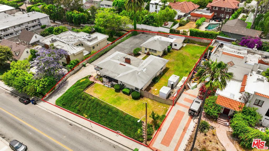 First time offered in decades. This one-of-a-kind 17,305 square foot lot on prime Mar Vista Hill offers endless opportunities. Possibilities include reconfiguring the existing lot, building an estate-like compound with two residences, a full ADU and a junior ADU, or remodeling the existing split-level home. The current home is a livable fixer with 3 bedrooms and 2 baths. Features include back-to-back fireplaces between the living and family rooms, hardwood floors throughout the main level, a dining room with mountain and city views, and a south-facing balcony with sweeping vistas from the mountains to the ocean. The detached two-car garage includes a three-quarter bathroom, and multiple sheds offer space for hobbies and storage. Nothing has been updated.