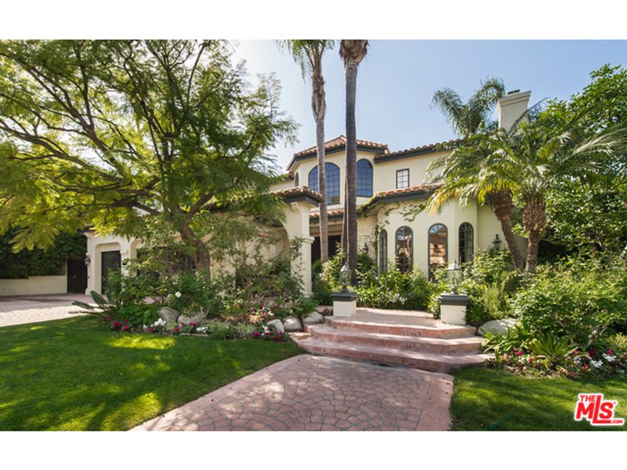 Stunning Mediterranean situated behind the guard gated Mulholland Estates. Redone with style and sophistication. The beautiful customized interior has a dramatic entry with high ceilings, venetian plastered walls and ebony stained oak hardwood floors throughout. Step down living room with fireplace, private office, formal dining, kitchen and family room with built-ins and wet bar. Sumptuous Master suite with two baths and closets, fireplace and terrace. Two additional generous en suite bedrooms upstairs and one maids room downstairs. Beautiful and private backyard with sparkling pool/spa and lush landscaping.