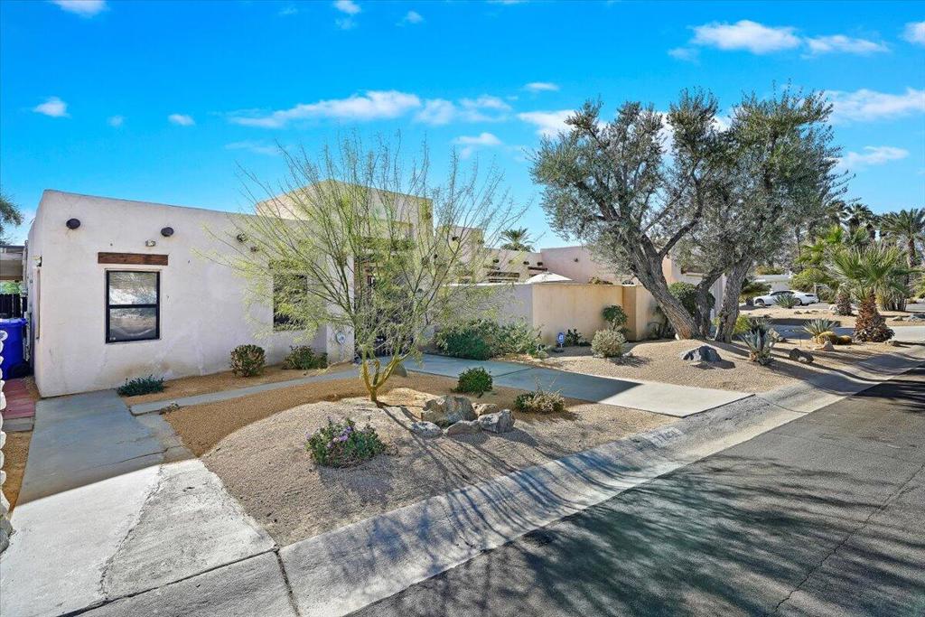 This charming 3-bedroom, 2-bath Santa Fe-style home blends cozy comfort with desert charm. Enjoy a stylish kitchen with island seating, a private hot tub, outdoor bonfire, and a dining area with scenic views. Located just minutes from the Tennis Garden, the home also features an office space with a Murphy bed, Spanish tile flooring throughout, and a washer/dryer for added convenience. Ideal for a relaxing getaway in a serene desert setting!