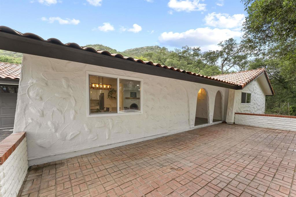 Discover an exceptional opportunity in the heart of Valley Center—a private flag lot featuring two detached residences situated on a sprawling five-acre parcel. This property is ideal for multi-generational living, extended families, guests, or potential rental income. The main residence has been tastefully renovated, offering a seamless blend of modern comfort and rustic charm. Its open-concept layout, stylish upgrades, and two-car garage create a warm and inviting space designed for comfortable everyday living. The second residence is a detached two-bedroom, one-bath home that provides both privacy and versatility, making it perfect for extended family, guests, or as an income-generating rental. Each home is separately metered for electricity and has its own septic system. The smaller unit operates on propane, while the main home is all-electric with the option to convert to propane if desired. Surrounded by peaceful natural beauty, this property offers expansive land, serene rural living, and a sense of seclusion—all while being just a short drive from local dining, shopping, and everyday conveniences.