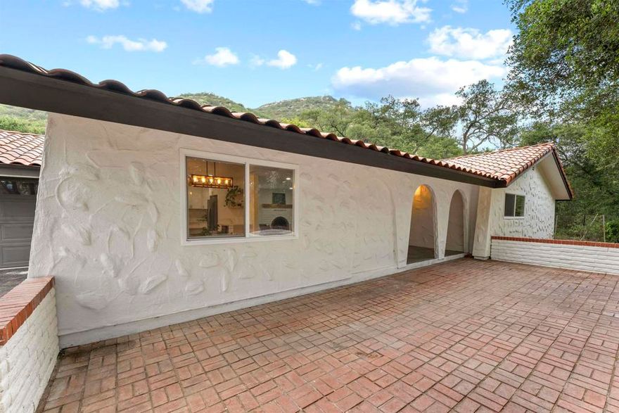 Discover an exceptional opportunity in the heart of Valley Center—a private flag lot featuring two detached residences situated on a sprawling five-acre parcel. This property is ideal for multi-generational living, extended families, guests, or potential rental income.  The main residence has been tastefully renovated, offering a seamless blend of modern comfort and rustic charm. Its open-concept layout, stylish upgrades, and two-car garage create a warm and inviting space designed for comfortable everyday living.  The second residence is a detached two-bedroom, one-bath home that provides both privacy and versatility, making it perfect for extended family, guests, or as an income-generating rental.  Each home is separately metered for electricity and has its own septic system. The smaller unit operates on propane, while the main home is all-electric with the option to convert to propane if desired.  Surrounded by peaceful natural beauty, this property offers expansive land, serene rural living, and a sense of seclusion—all while being just a short drive from local dining, shopping, and everyday conveniences.