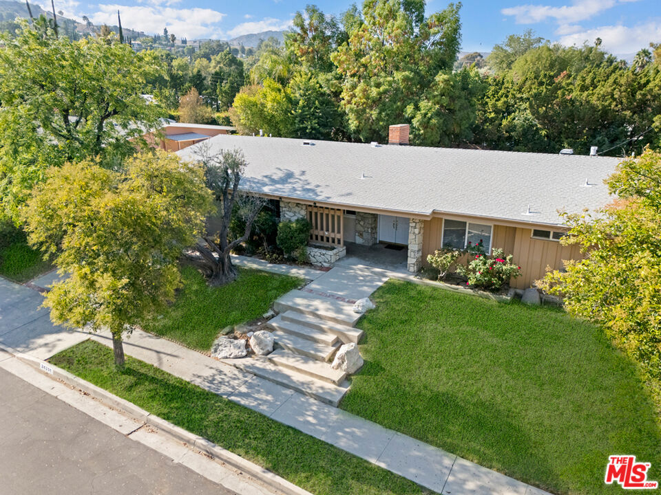 Mid-Century Design by world-renowned Architect "Charles Dubois". Welcome to this beautifully updated single-level home nestled on a picturesque tree-lined street, in one of Woodland Hills' most sought-after neighborhoods. Boasting 5 spacious bedrooms, 3 modern bathrooms, and over 2,700 square feet of living space, this home offers the perfect blend of style, comfort, and functionality. Step inside to soaring vaulted ceilings and an open floor plan that fills the home with natural light. The recently renovated kitchen features sleek countertops, ample cabinetry, and newer stainless steel appliances, ideal for the ultimate entertainer. Central air and heat ensure year-round comfort throughout the home. Situated on a generous nearly 11,000-SQFT lot, the property includes a lush, private backyard perfect for entertaining or relaxing in the California sun. The attached 2-car garage offers direct access to the home for added convenience. With easy access to the 101 Freeway and just minutes from Country Wide Top-Rated schools, shopping, dining, and parks, this home offers the best of Woodland Hills living.