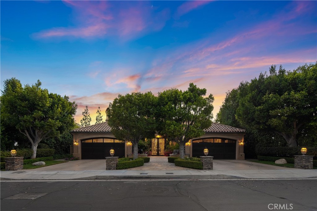 Tucked away on a quiet cul-de-sac in the prestigious 24-hour guard-gated community of Bel Air Crest, this Mediterranean-inspired estate seamlessly blends old-world charm with modern luxury and sophistication. Double doors welcome you into a dramatic foyer highlighted by double-height ceilings and a grand curving staircase, setting the tone for the refined interior beyond. At the heart of the home lies a gourmet chef’s kitchen equipped with top-of-the-line appliances and a sun-drenched breakfast nook. Adjacent, the warm and inviting family room boasts a custom wet bar and multiple French doors that open to extend your living space outside. Completing the main level is a spacious living room, elegant formal dining room and wood paneled den/office. Upstairs, four generously sized ensuite bedrooms each offer a walk-in closet, including a luxurious primary suite with two ensuite bathrooms and two custom walk-in closets. Designed with entertaining in mind, the lower level showcases a spacious rec room, bonus room and ensuite bedroom – each with French doors that open directly to the backyard. There’s also a private sauna, dedicated laundry room and ample storage space. Enveloped by lush greenery, the private backyard retreat is a true sanctuary, featuring resort-style amenities such as a sparkling pool/spa, summer kitchen, built-in firepit and a series of tiered patios. Additional highlights include dual two-car garages and access to the exclusive Bel Air Crest community amenities, which offers a newly renovated clubhouse, state-of-the-art fitness center, multiple sports courts, a pool/spa, putting green, playground and dog park. This property is ideally located with easy access to both the Westside and Valley, and nearby top-rated public and private schools.