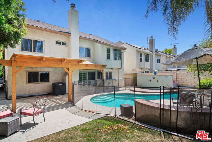 Nestled on a serene tree-lined street in the heart of Tarzana, this beautifully updated California traditional offers 5 bedrooms and 3 bathrooms across two spacious levels. A formal entry opens into a light-filled interior with soaring ceilings, leading to the elegant living and dining rooms, perfect for gatherings and entertaining. The updated kitchen boasts quartz countertops, a custom glass tile backsplash, double pantry, and a charming breakfast nook. Just off the kitchen, the inviting family room features a classic brick fireplace and sliding glass doors that open to a private backyard retreat. Outdoors, enjoy a heated pool and jacuzzi, a pergola-covered patio ideal for al fresco dining, and a cozy lawn perfect for relaxation or recreation. The main level includes a versatile bedroom with a full bath, along with a spacious laundry room. Upstairs, the expansive primary suite offers a large ensuite bath with a soaking tub, separate walk-in shower, and generous closet space. Three additional bedrooms share a full bath with dual sinks. Additional upgrades include new front siding, a new furnace, a new pool & spa heater and a new water heater. This home combines comfort, style, and functionality in one of Tarzana's most desirable neighborhoods, an exceptional opportunity not to be missed.