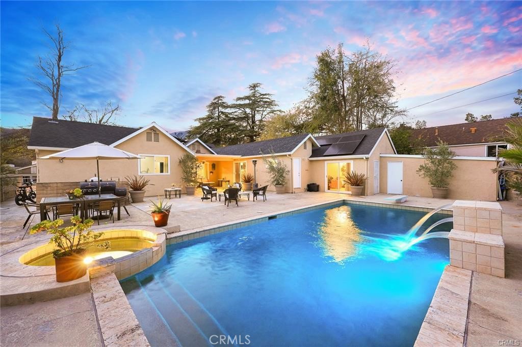 Welcome to this charming home in the heart of Glendale Woodlands Area spanning over 2,200 square feet, within walking distance to Verdugo Woodlands elementary school. This residence offers a Circular Driveway for easy ingress/egress, traditional layout with 4 bedrooms and 3 full bathrooms or 3 bedrooms with a family room. Tile and hardwood flooring throughout the house, fireplace in the Living room highlight the home's inviting character. The formal dining room connects to an updated kitchen equipped with ample storage, natural stone countertops next to the laundry area. Resort style all flat back yard with a pool and spa with covered and open patios create the perfect oasis for entertaining and unwinding. Additionally, there are solar panels as well as a EV charger to the side of the house. Short term lease considered. None smoker please. pool man and Gardner fees paid by landlord. Tenant responsible for all utilities including water, electricity and gas. Renters insurance is required.