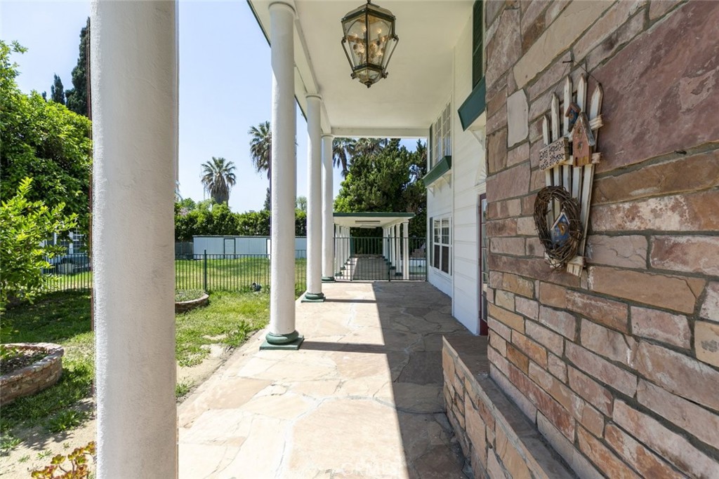 A rare and distinguished offering in the heart of Van Nuys, this 6-bedroom, 5-bath Colonial-style estate spans 2,923 square feet of timeless charm and endless potential. Showcasing classic architectural elegance, the home welcomes you with a grand facade framed by towering columns, a vibrant red entry door, and a picturesque tiered fountain that anchors the lush front garden.
Inside, rich hardwood floors flow throughout expansive formal living and dining spaces, adorned with original character details including French doors, custom millwork, and vintage lighting fixtures. The spacious layout offers seamless flow for both everyday living and large-scale entertaining. A bright, well-appointed kitchen features tile countertops, ample cabinetry, and a built-in breakfast nook overlooking the greenery—a perfect space to start your day.
The upper level offers multiple oversized bedrooms and flexible-use rooms that can easily function as offices, studios, or guest quarters. Downstairs, additional living areas provide plenty of space to accommodate multigenerational needs or creative setups.
Out back, a covered veranda leads to a sparkling swimming pool surrounded by mature landscaping, offering privacy and tranquility. The deep lot includes multiple lounging areas, a 2 bedroom and 1 bath guest house, a detached garage, and ample driveway parking. With its blend of historical appeal and generous footprint, this iconic residence offers an incredible opportunity to restore, customize, or enjoy as-is. A true gem waiting to be rediscovered.