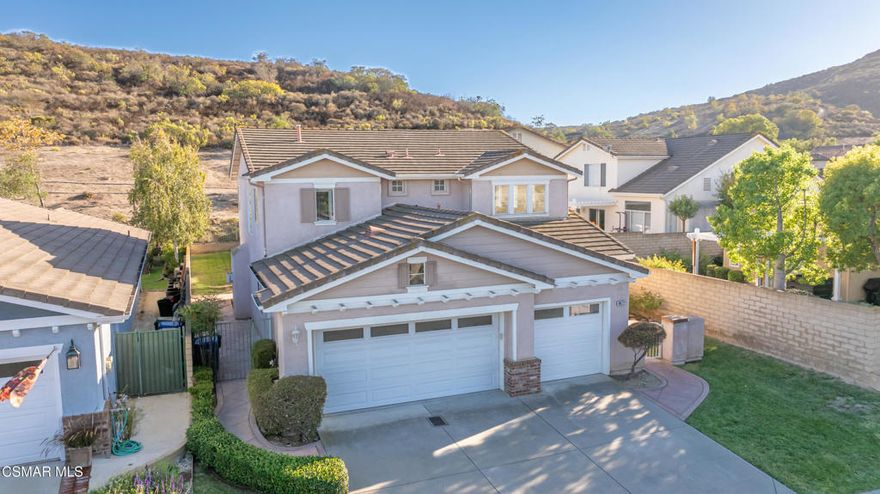 Incredible two story Harvest Moon home in Dos Vientos! Popular open floor plan w/Cathedral Ceilings and Designer Paint. Downstairs Bedroom & Bath, Formal Living & Dining Room. Gourmet Kitchen w/Gorgeous Tile Counters, Stainless Appliances, Pantry, Opens to Spacious Family Room with Fireplace. Glass Sliders to Yard w/ big grass area and Lush Landscaping. Patio perfect for Dining Alfresco. Upstairs Laundry, built-in desk area in hallway. Master Suite with large walk-in closet, Bath with dual vanities, tub & Shower. Additional bedroom and bonus spacious loft upstairs.  Three Car Garage, Prime Location on Cul-de-Sac. Access to Private Community Pool and Spa, Private Park with Playground. Close to Sycamore Canyon K-8 School, Public Parks, The Village Shopping Center. An Amazing Offer!
